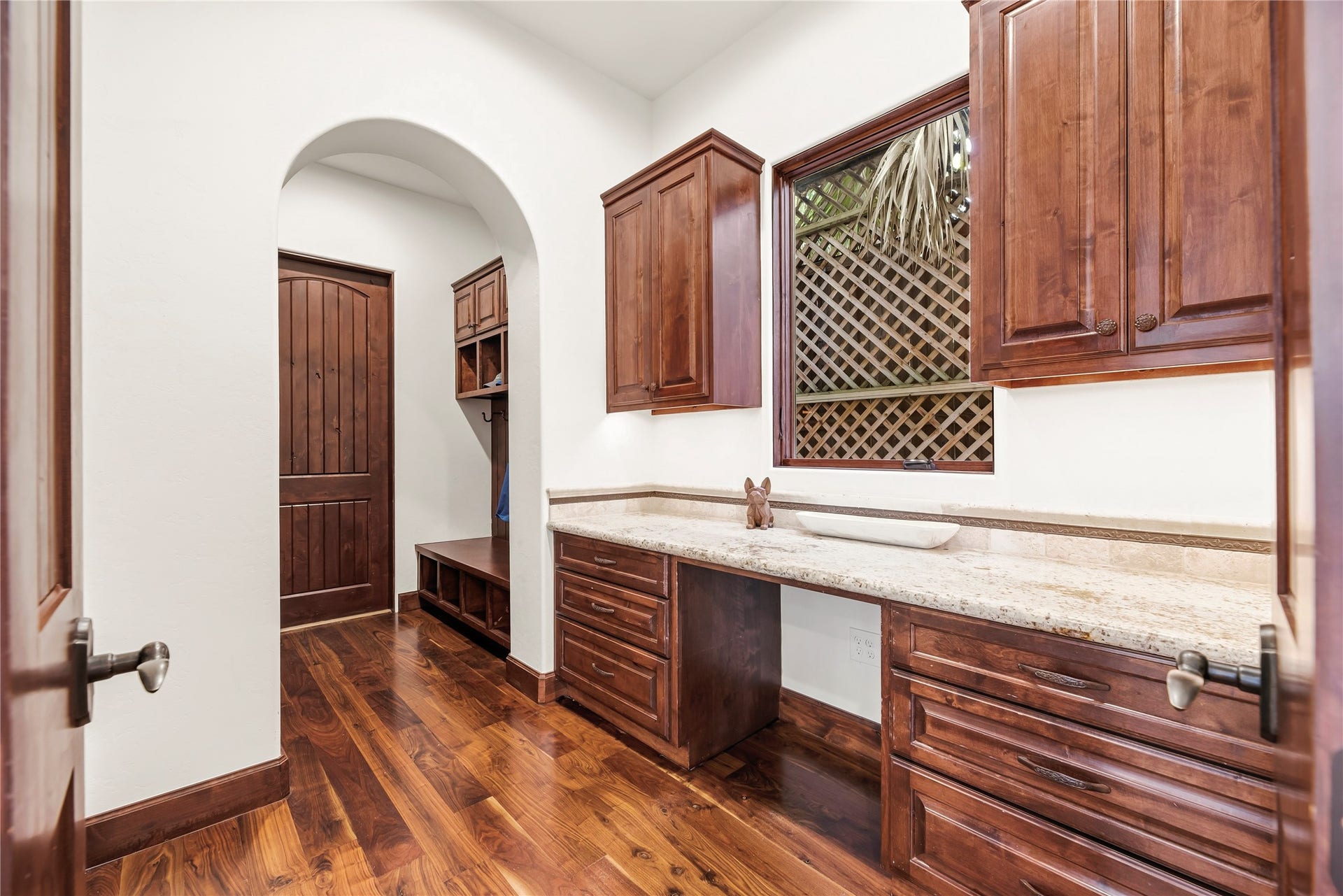 3803 Drake Street, Houston, TX 77005 This practical study nook and mudroom combination features custom built-ins and granite surfaces, creating a refined yet efficient space for managing a busy household.
