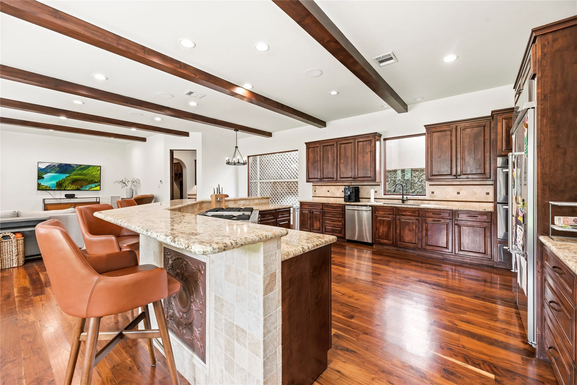 3803 Drake Street, Houston, TX 77005 This chef-inspired kitchen features premium granite, a high-end gas range with griddle, and double ovens, perfectly blending professional-grade utility with sophisticated style.