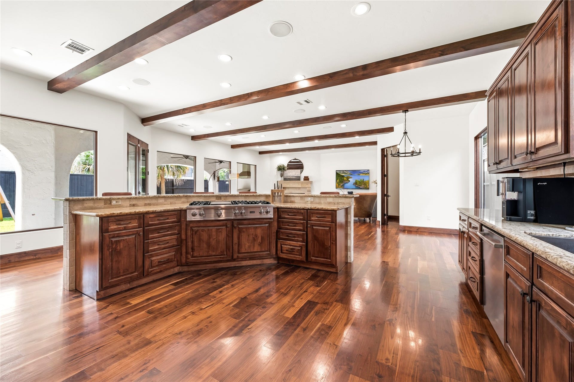 3803 Drake Street, Houston, TX 77005 The oversized island features a built-in gas cooktop and breakfast bar seating, making it the functional centerpiece of this grand culinary space.