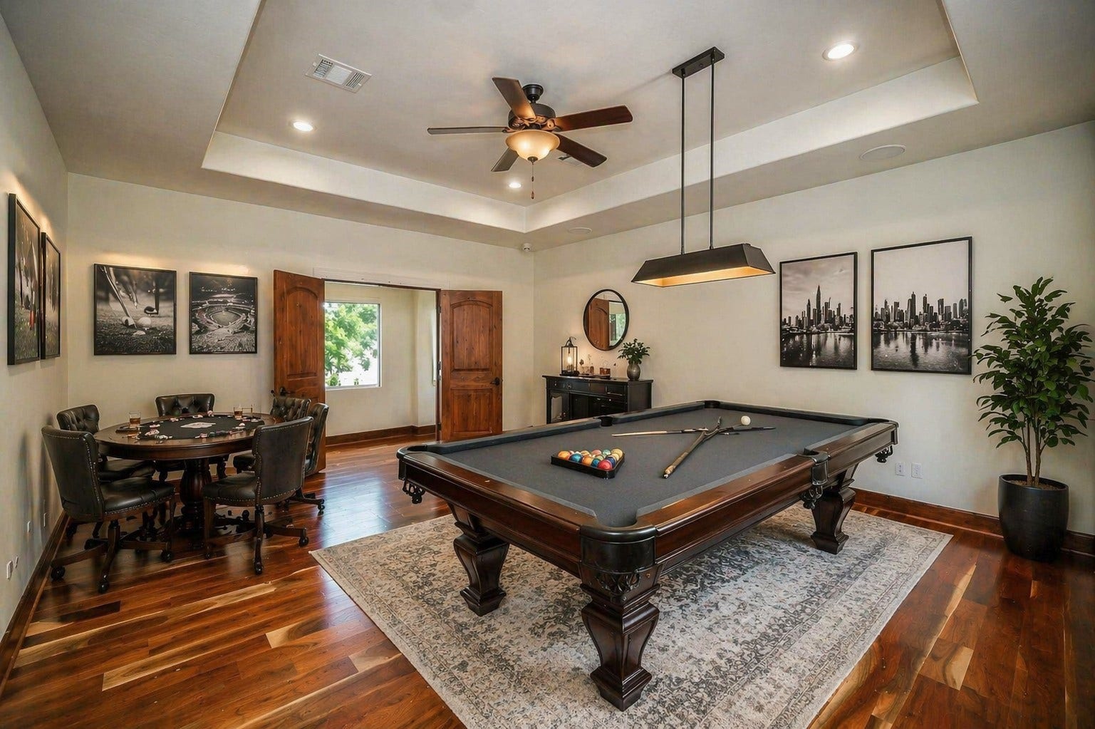 3803 Drake Street, Houston, TX 77005 This expansive upstairs gameroom is defined by elegant tray ceilings and custom shutters, featuring grand double-door entry that opens to a flexible sanctuary for play or media entertainment. Virtually staged.