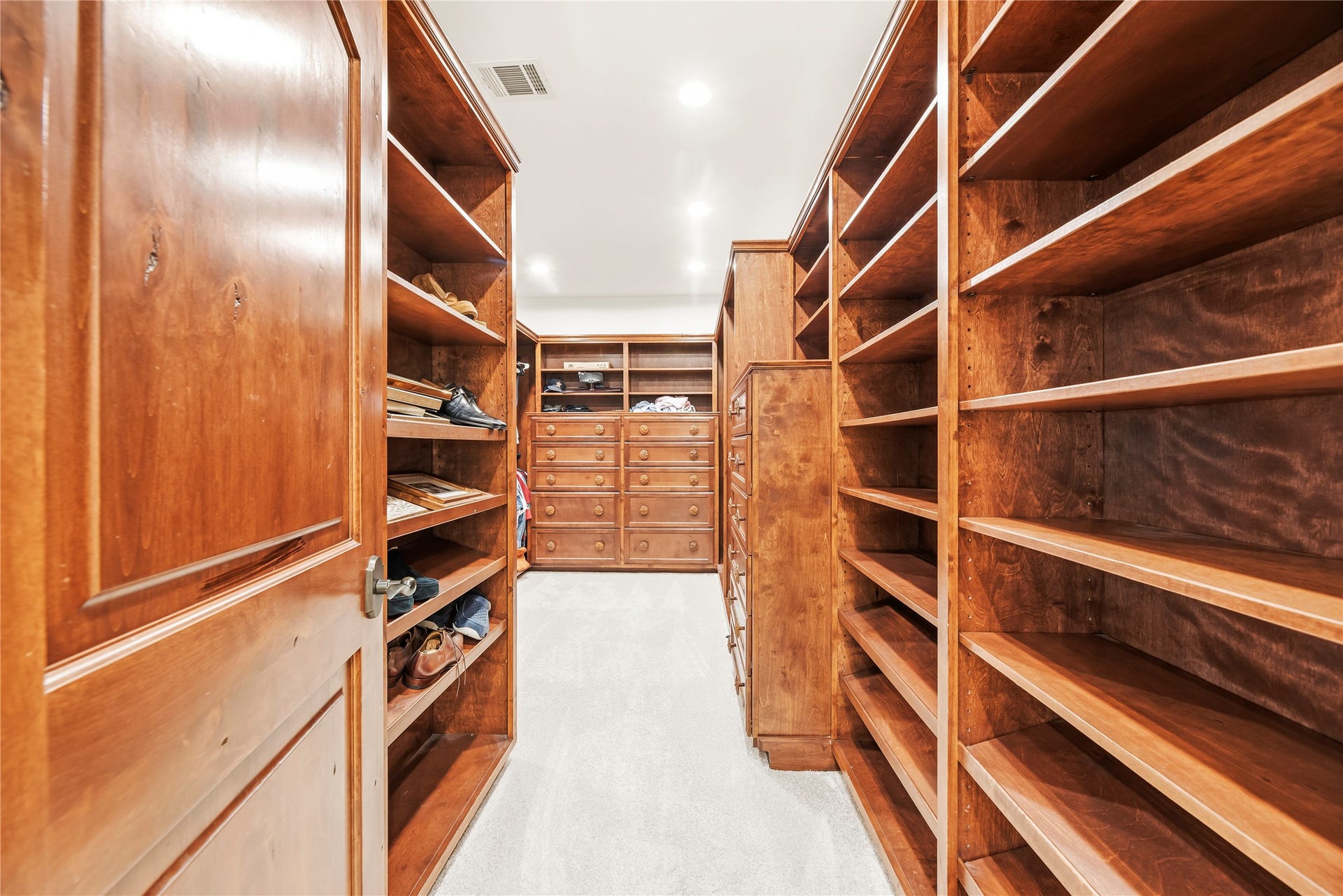 3803 Drake Street, Houston, TX 77005 The oversized walk-in closet features floor-to-ceiling custom shelving and drawers, offering a high-end solution for a meticulously organized wardrobe.