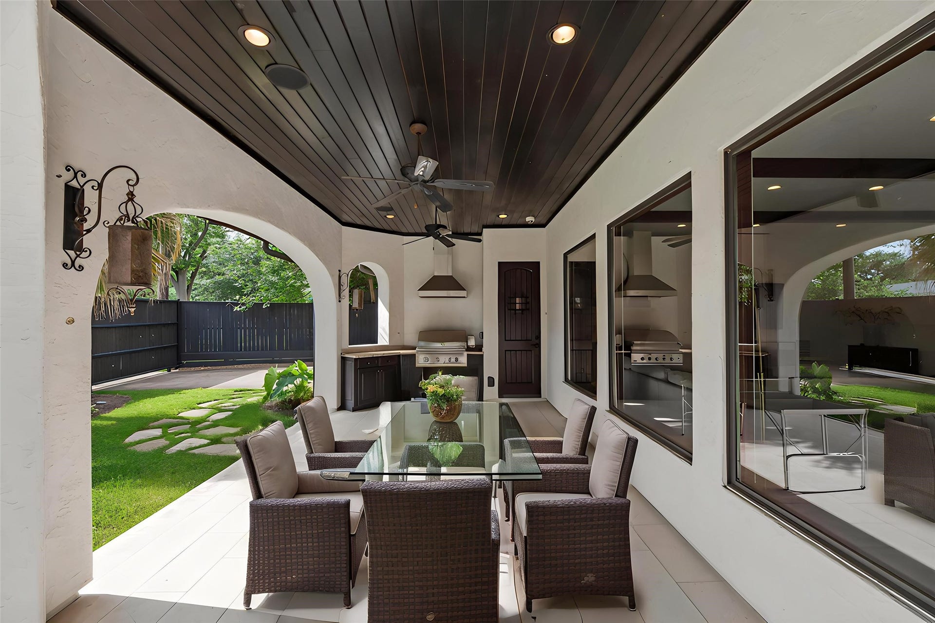 3803 Drake Street, Houston, TX 77005 The covered patio features custom wood-plank ceilings and recessed lighting, creating a seamless transition for elegant outdoor entertaining. Virtually staged.