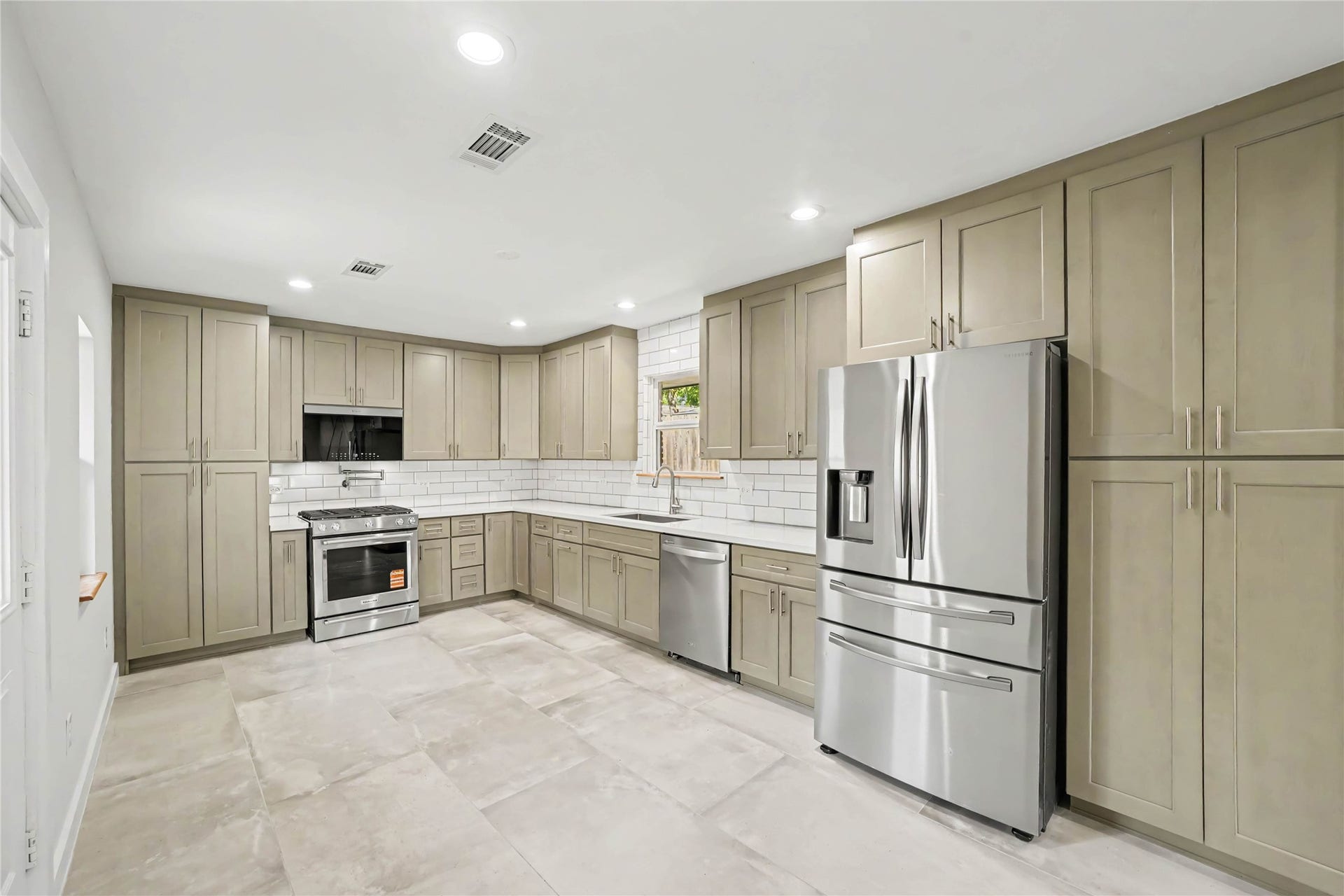 4709 Sanborn Drive, Houston, TX 77092 The kitchen is spacious and has a panty on the far left and additional storage on the far right where the tankless water heater is located.
