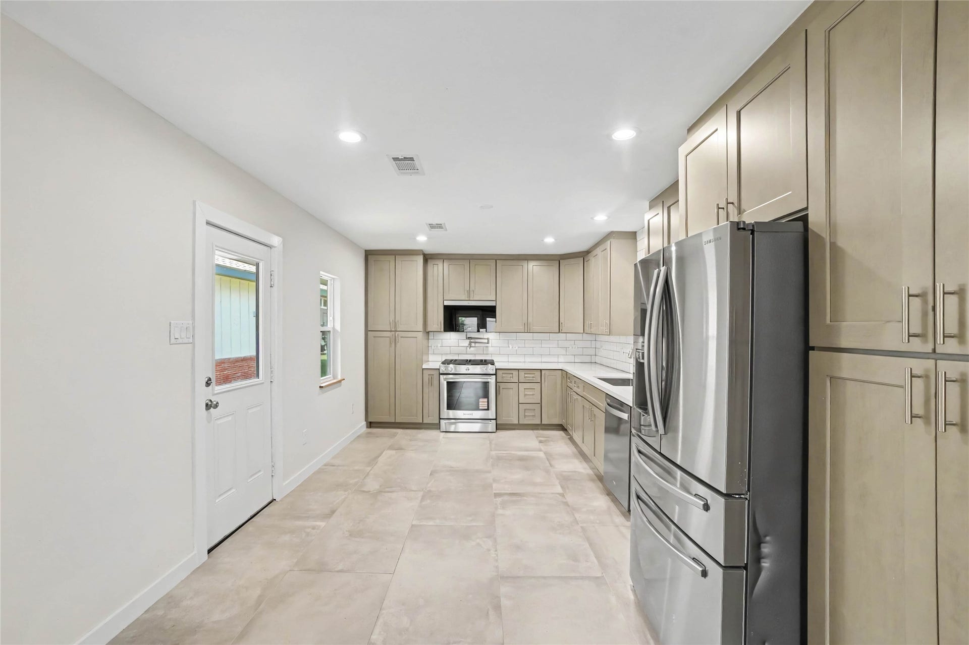 4709 Sanborn Drive, Houston, TX 77092 Kitchen was gutted and is ready to be utilized! 36" cabinets, subway tile backsplash, pot filler, Kitchen Aid 5 burner gas cooktop and gas oven. You'll love the Whirlpool microwave/air fryer combo and the Samsung stainless 2 door fridge with 2 drawer freezer (included).
