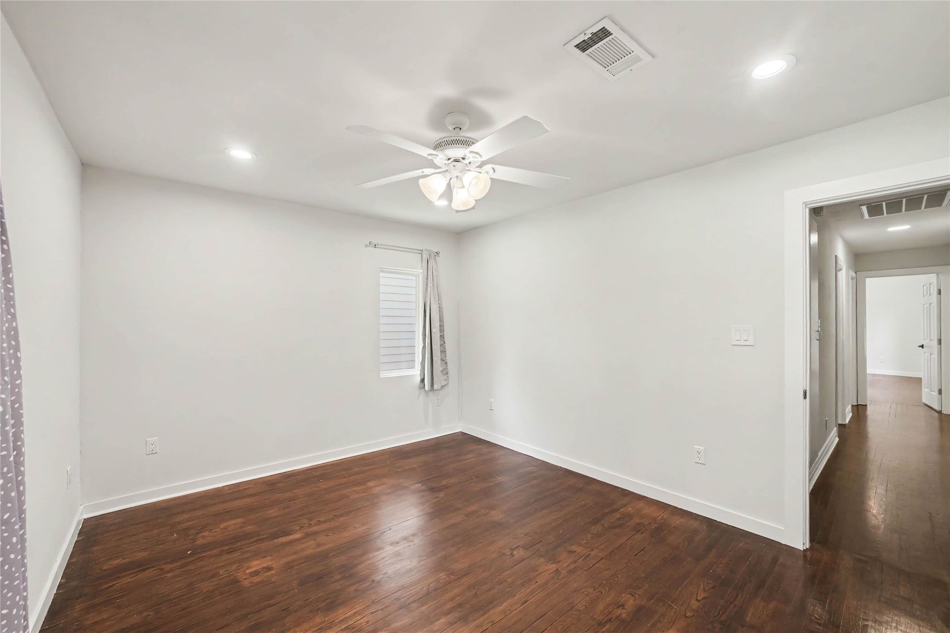 4709 Sanborn Drive, Houston, TX 77092 The wood floor from this bedroom extends down the hallway where you'll find the next secondary bedroom.