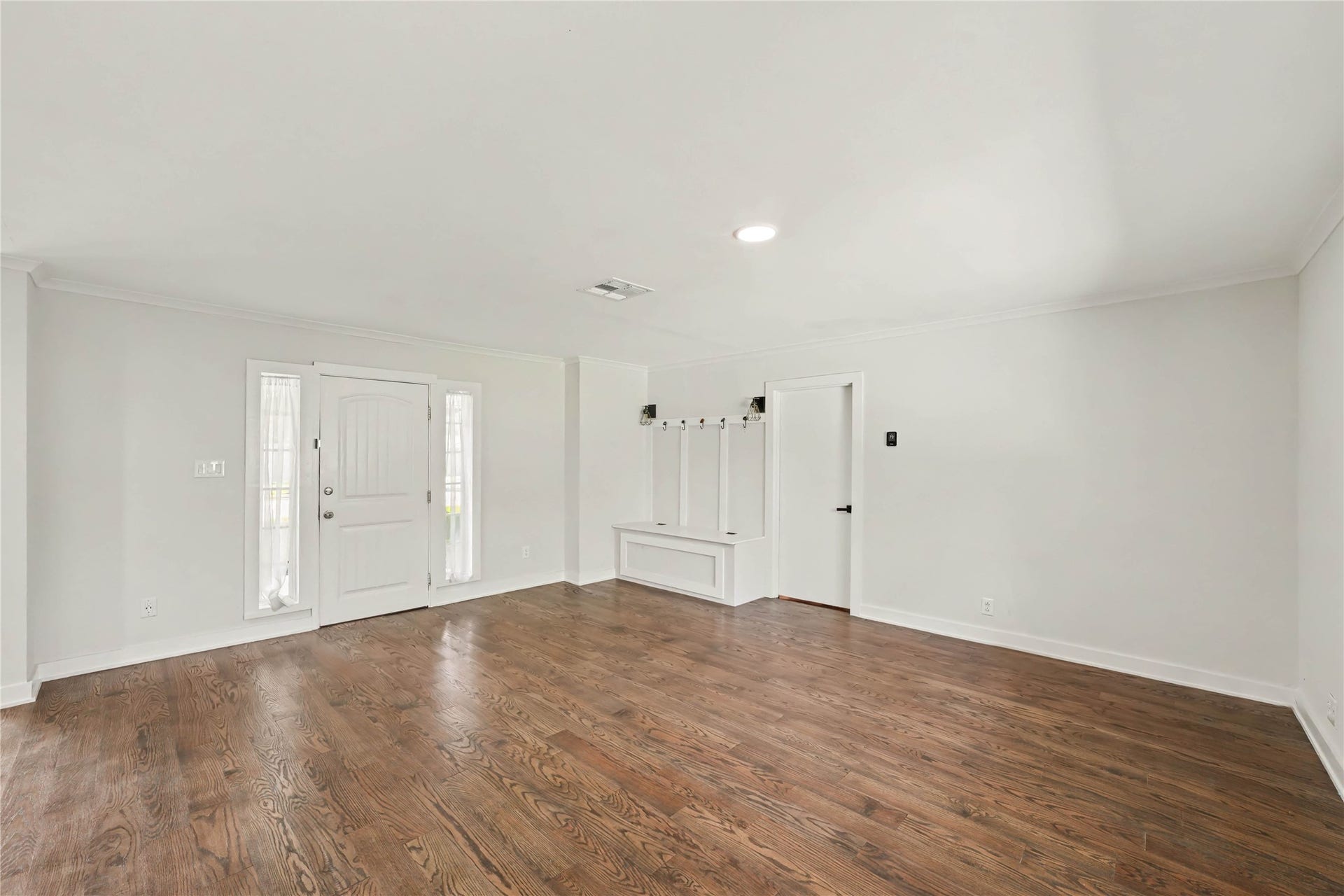 4709 Sanborn Drive, Houston, TX 77092 Upon entering, enjoy having this large, open living area. You have a backpack rack with storage underneath and decorative fixtures. The door on the right goes into the hallway where the bedrooms are.
