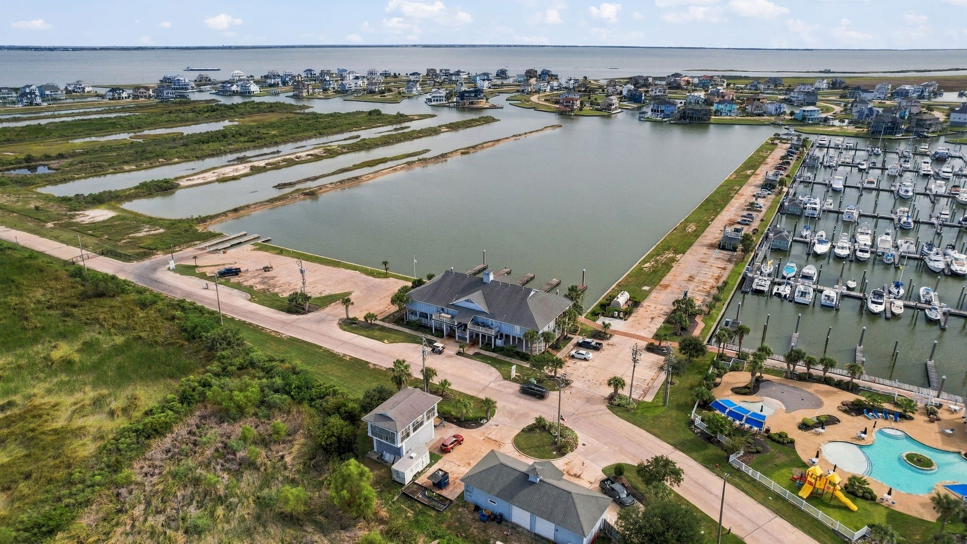 26 Half Moon, Hitchcock, TX 77563 Prime waterfront living with direct marina access, offering stunning views and a vibrant community atmosphere. Ideal for boating enthusiasts.