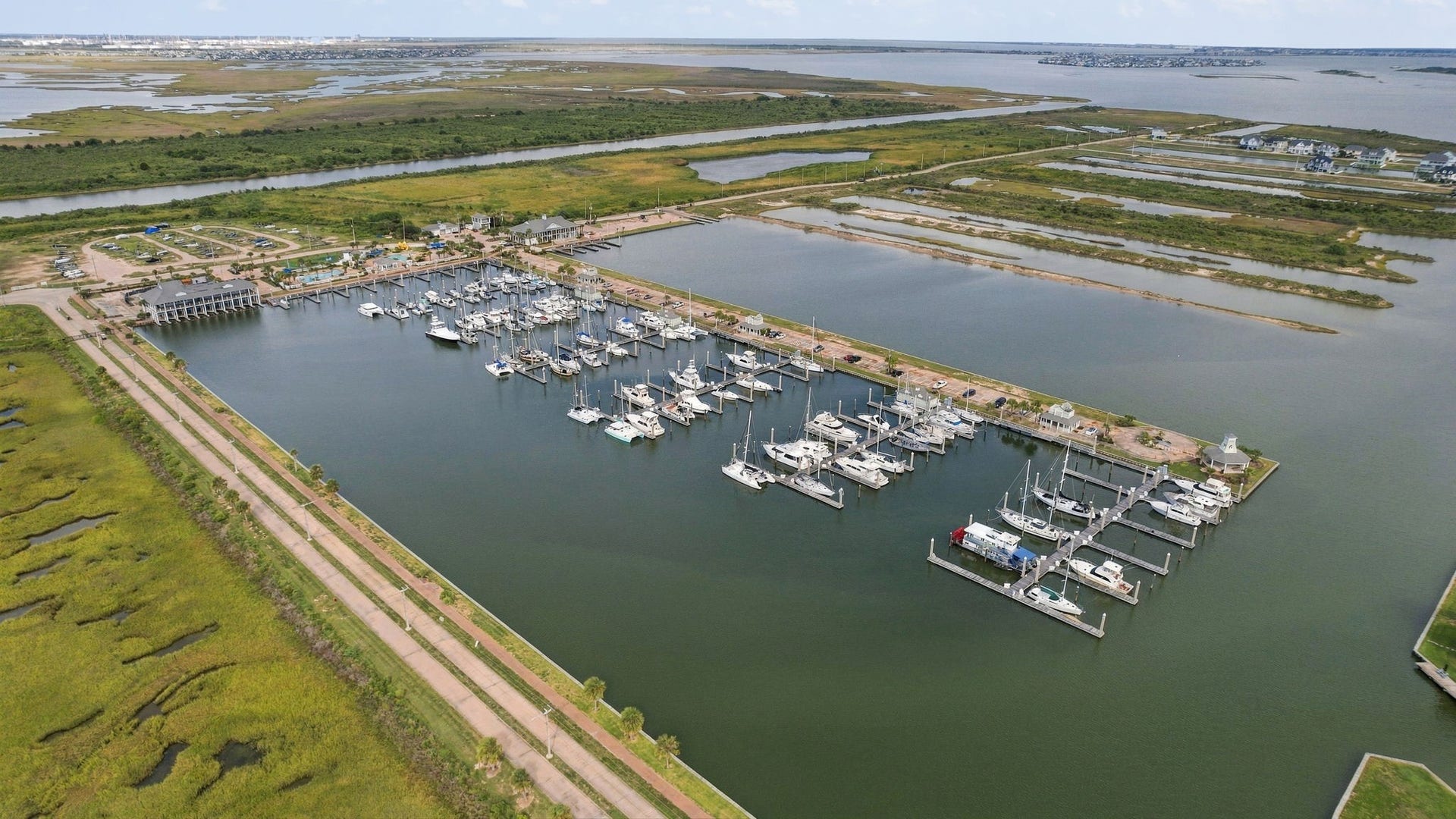 26 Half Moon, Hitchcock, TX 77563 Nestled along serene waterways, this picturesque marina offers ample dock space and stunning views, ideal for boating enthusiasts seeking a tranquil coastal lifestyle.