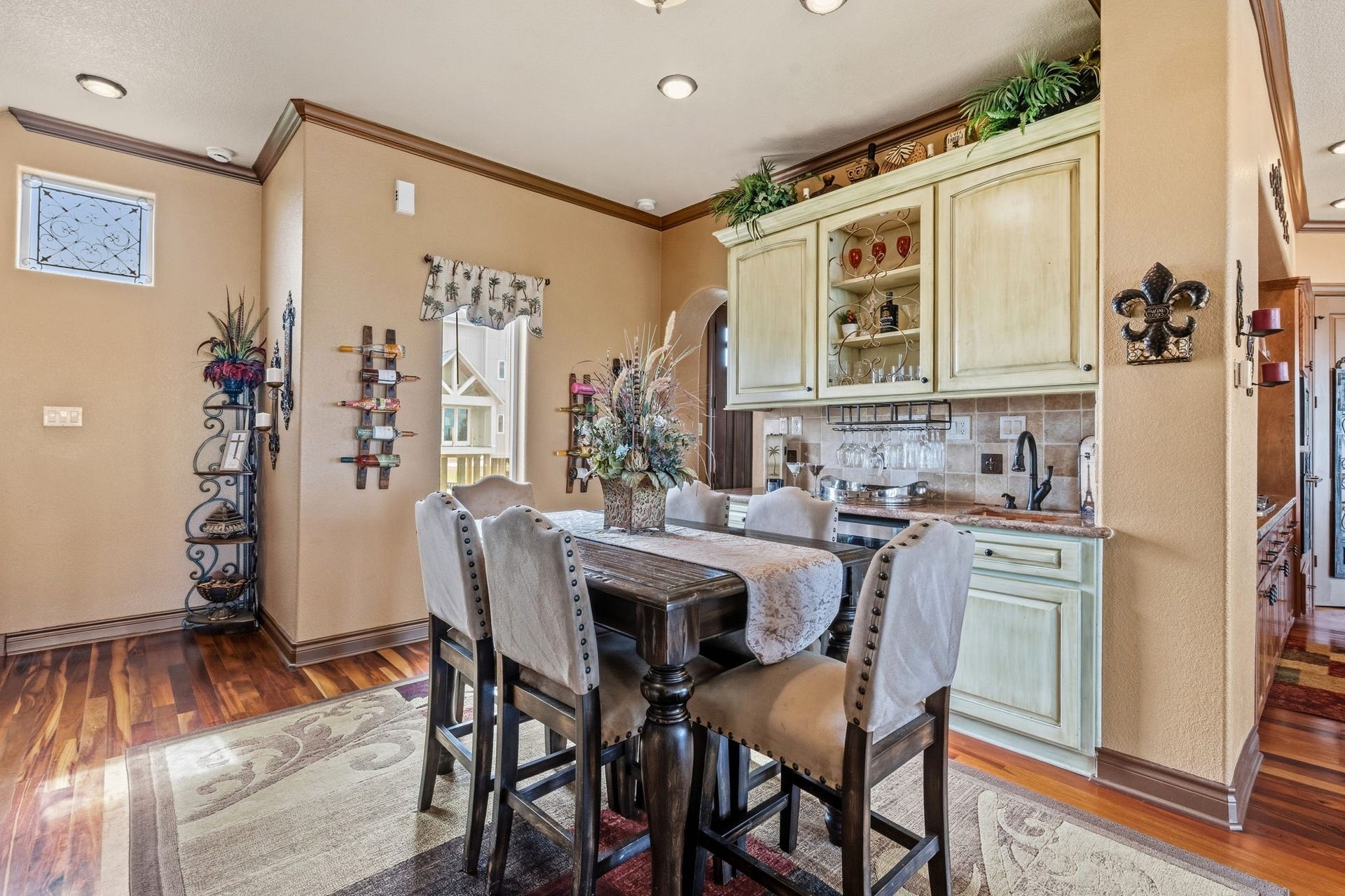 26 Half Moon, Hitchcock, TX 77563 Charming dining area with elegant cabinetry, cozy seating, and warm hardwood floors, perfect for intimate gatherings.