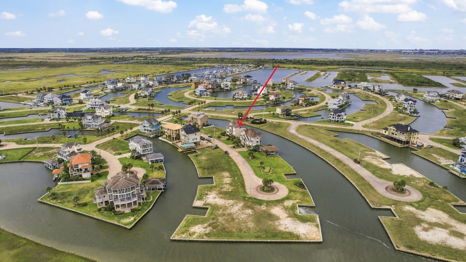 26 Half Moon, Hitchcock, TX 77563 Stunning waterfront property nestled in a serene, picturesque community with winding canals and lush greenery, offering a perfect blend of tranquility and luxury.