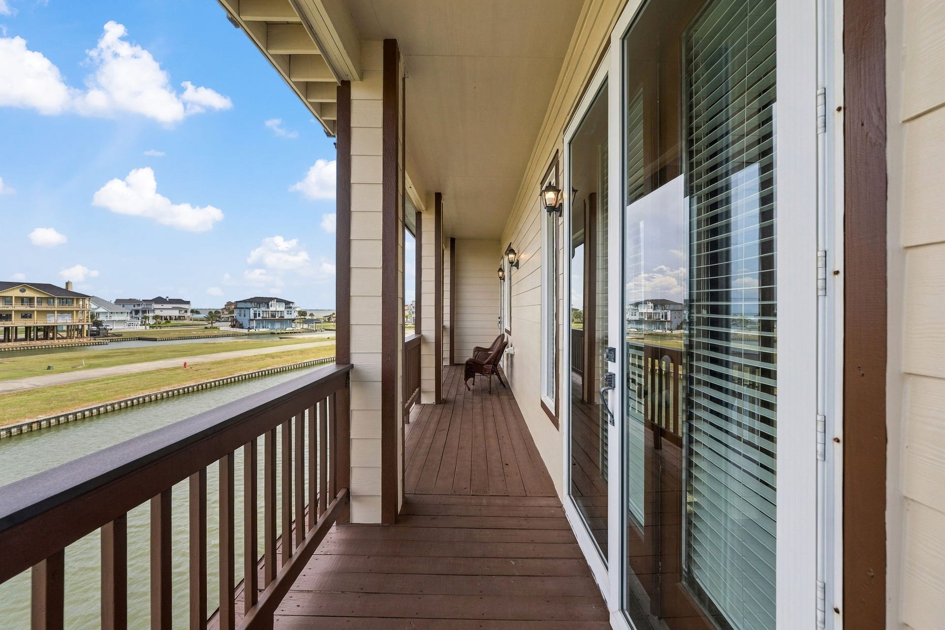 26 Half Moon, Hitchcock, TX 77563 Enjoy serene waterfront views from this spacious balcony, perfect for relaxing and soaking up the coastal atmosphere.