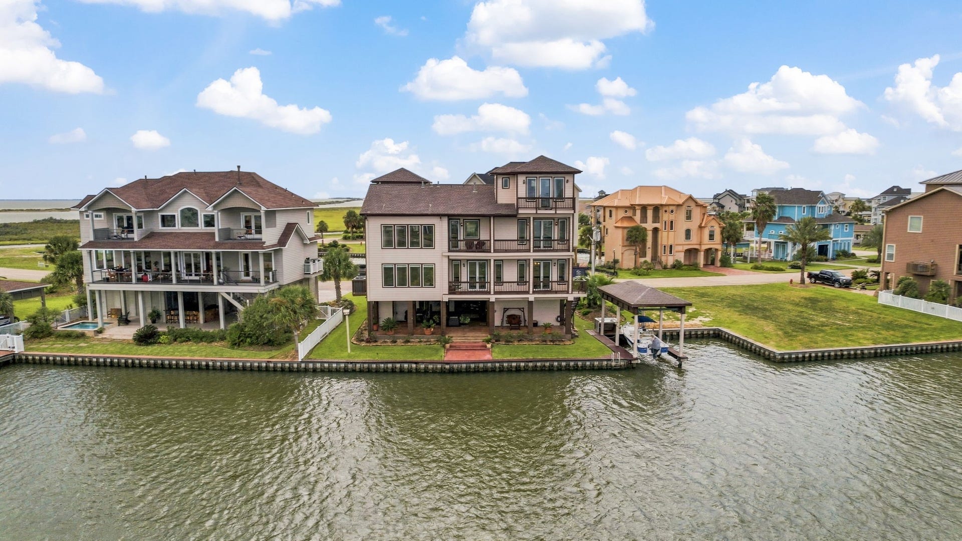 26 Half Moon, Hitchcock, TX 77563 Stunning waterfront homes with private docks, offering serene canal views and spacious outdoor living areas, perfect for enjoying tranquil waterside living.