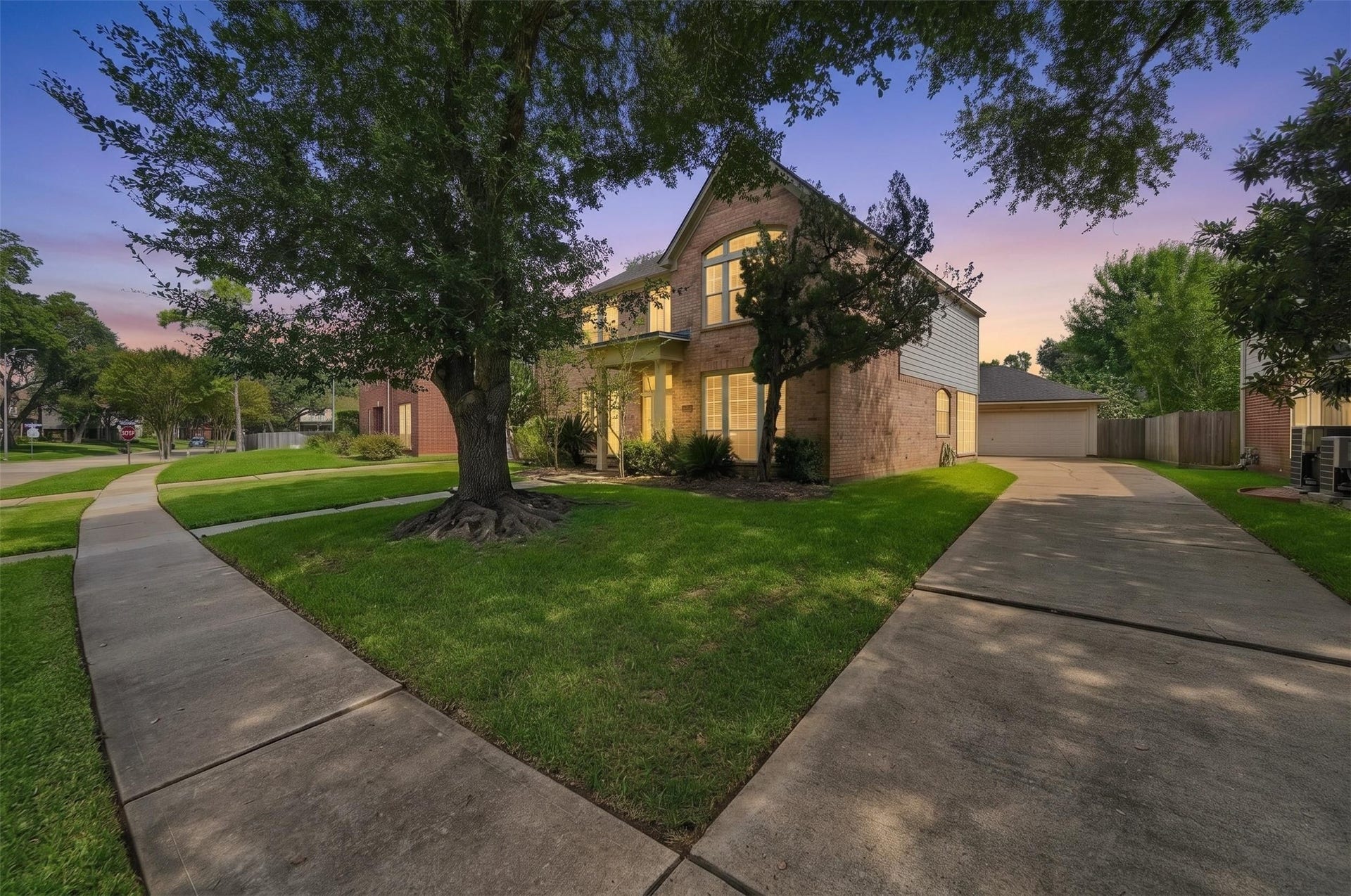 4907 Cambridge Street, Sugar Land, TX 77479 The single wide driveway trails beside the home leading to the two car garage nestled behind the home. Virtually enahnced.