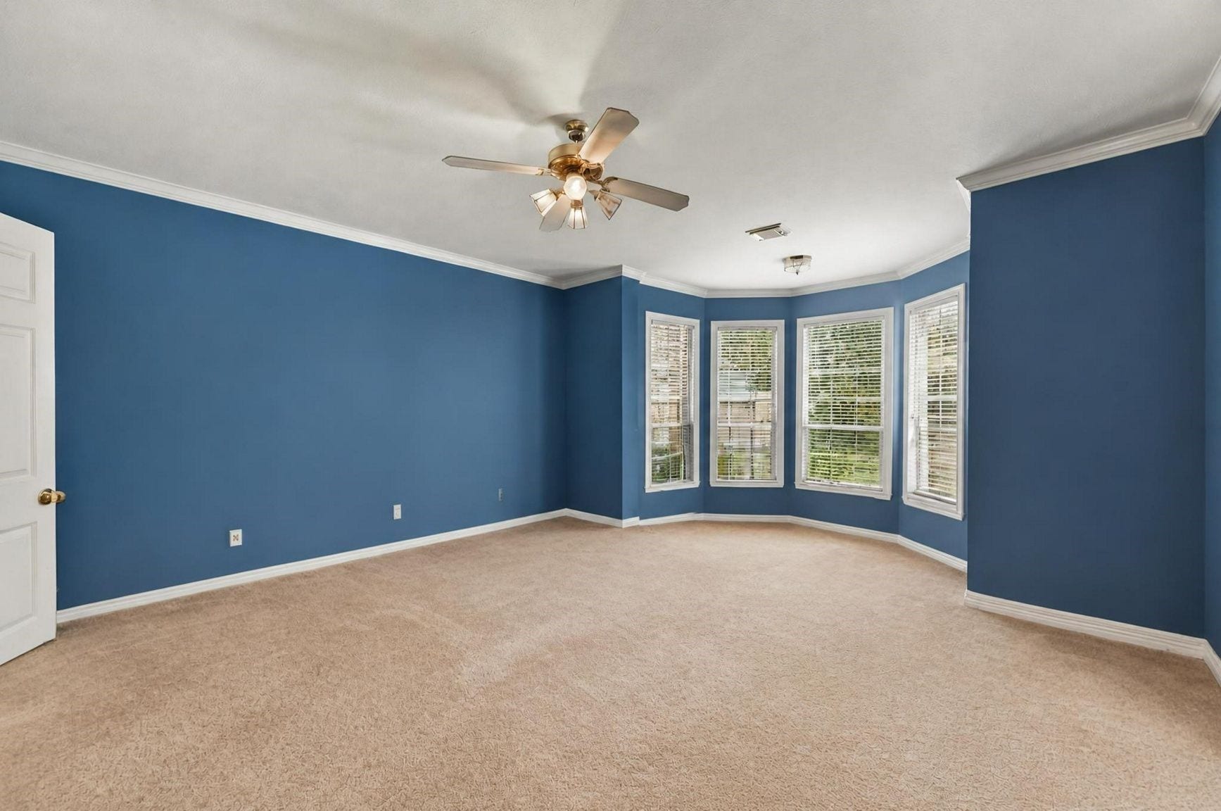 4907 Cambridge Street, Sugar Land, TX 77479 The primary bedroom featuring large bay windows.