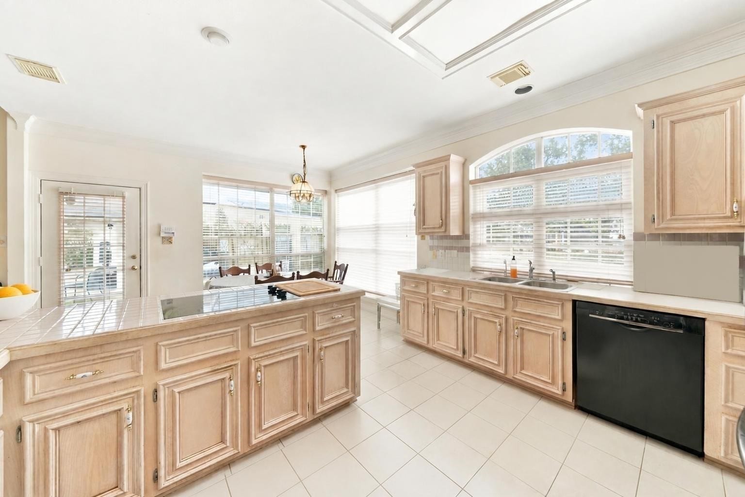4907 Cambridge Street, Sugar Land, TX 77479 The kitchen is open to the first floor and offers a long L-shaped island with an electric cooktop.