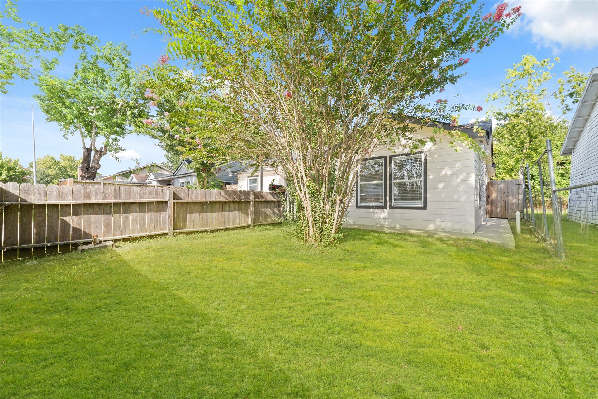 7125 Conley Street, Houston, TX 77021 Large grassy backyard behind the two dwellings. Welcome home to 7125 Conley. This adorable home is move-in ready now.