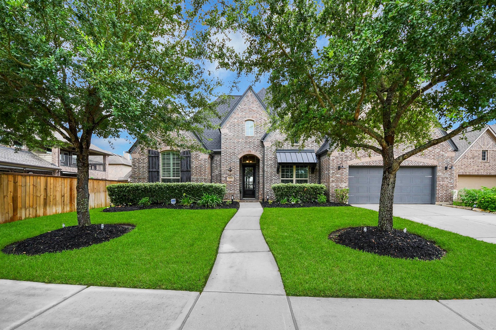 20623 Long Way Trace, Richmond, TX 77406 Inviting front walkway welcomes you home with mature trees and lush green lawn.