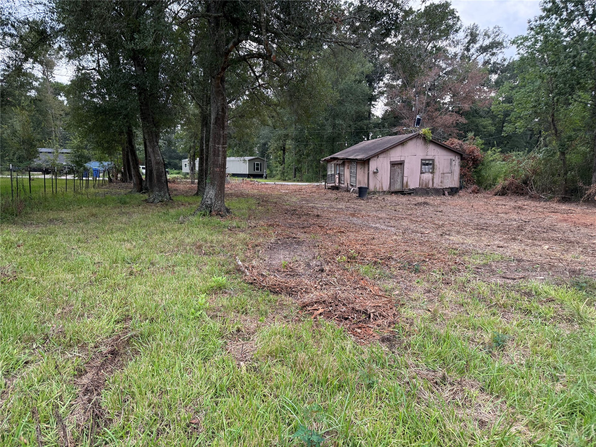 26331 Long Street, Splendora, TX 77372 Spacious cleared acreage with existing home and mature trees in Patton Village.