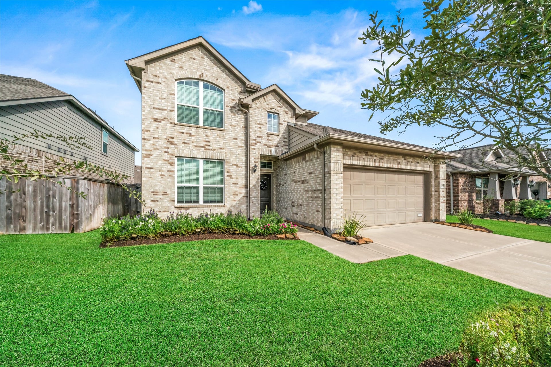 4509 Whitehaven Pine Way, Rosharon, TX 77583 Stunning two-story brick home with a spacious two-car garage, manicured lawn, and charming landscaping, offering great curb appeal in a welcoming neighborhood.