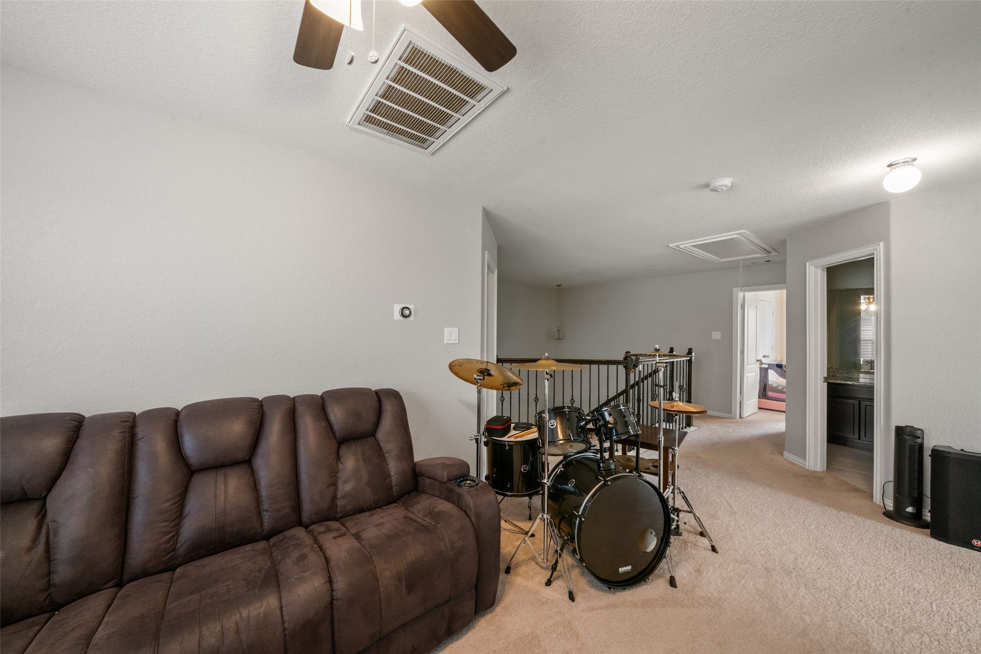 4509 Whitehaven Pine Way, Rosharon, TX 77583 Spacious upstairs area featuring a cozy seating nook and room for entertainment, ideal for relaxation or hobbies.