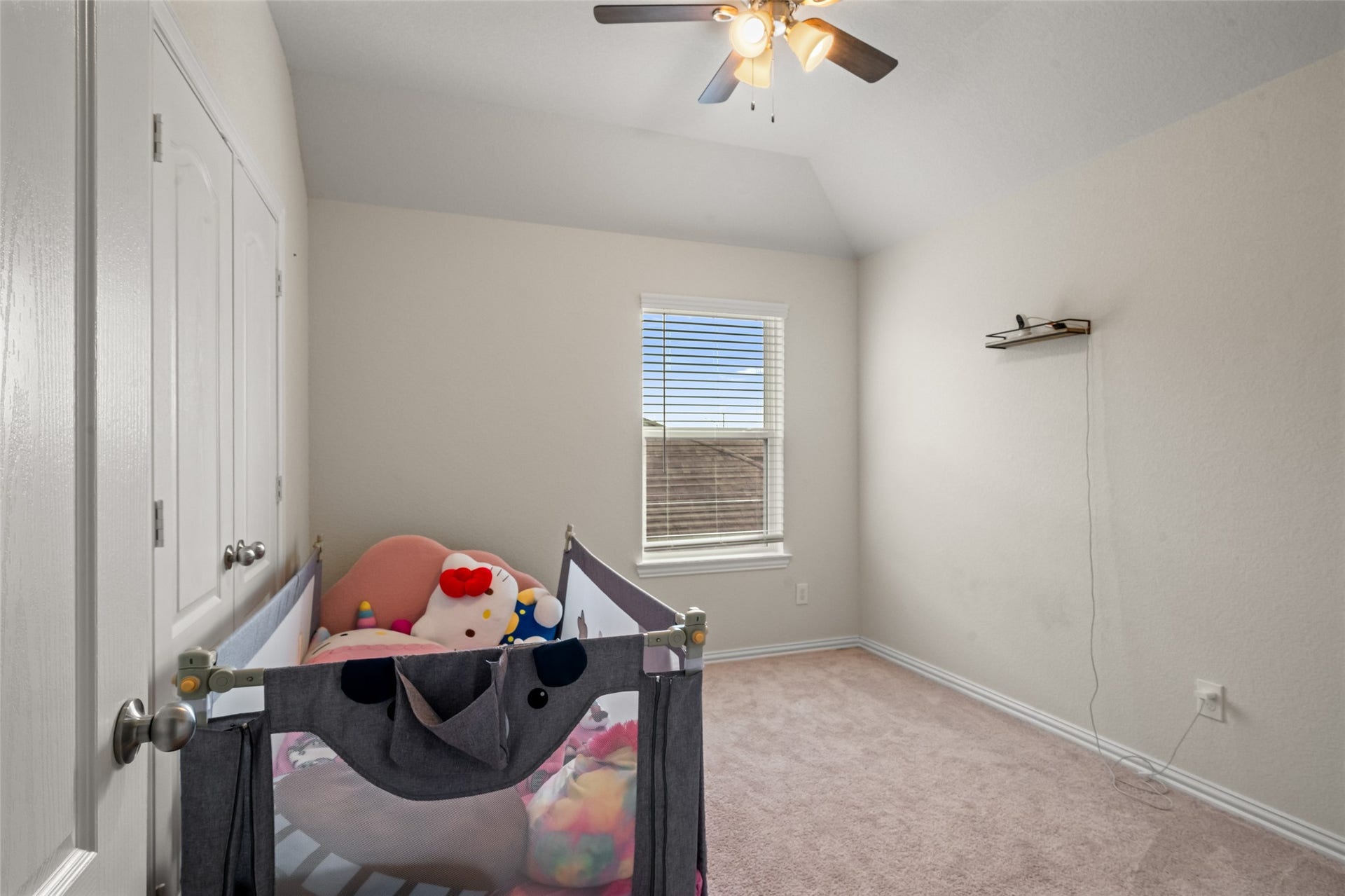 4509 Whitehaven Pine Way, Rosharon, TX 77583 Cozy nursery with soft carpeting, a ceiling fan, and natural light from a large window, offering a serene space for your little one.