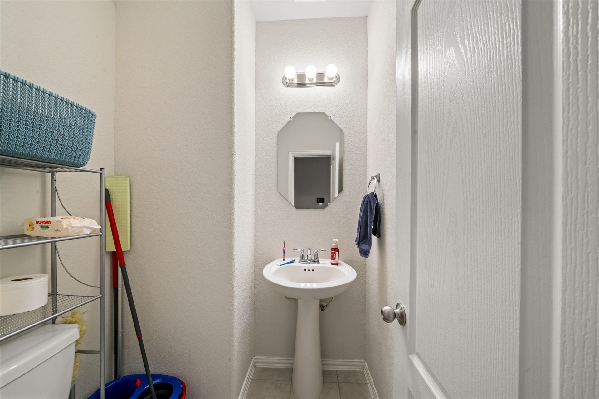 4509 Whitehaven Pine Way, Rosharon, TX 77583 Compact powder room with a pedestal sink, mirror, and enough room to add shelving of your desire.