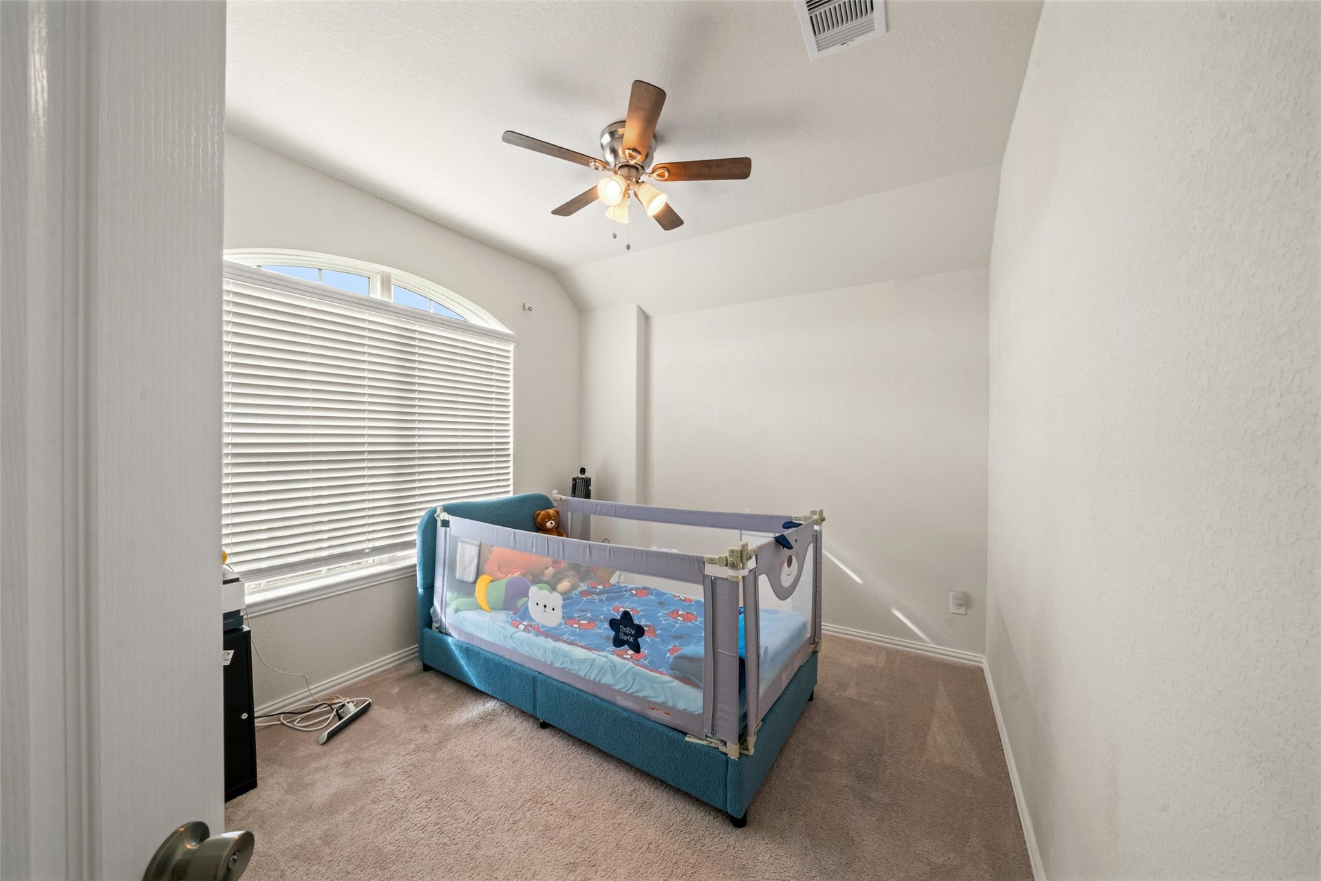 4509 Whitehaven Pine Way, Rosharon, TX 77583 Cozy bedroom with soft carpeting, abundant natural light from a large window, and a ceiling fan for comfort.