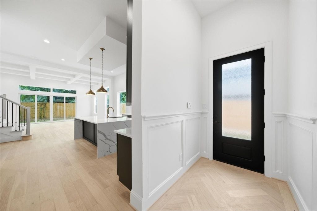 1320 Alexander Street, #A, Houston, TX 77008 Welcoming front door entry with custom wall paneling and herringbone oak floors.