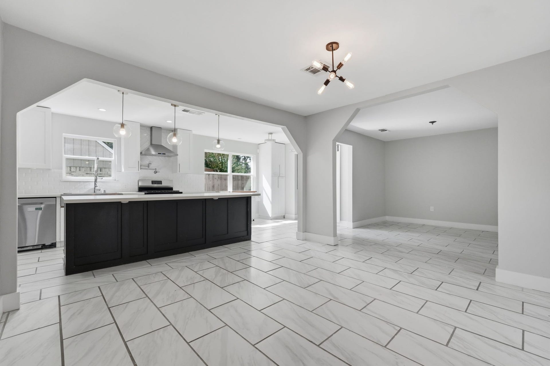 The open-concept kitchen and dining rooms are bright and modern, perfect for hosting and entertaining.