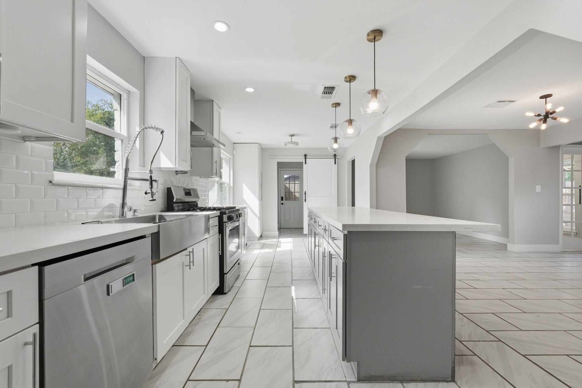 The large kitchen with a spacious island, seamlessly flows into the rest of the house.