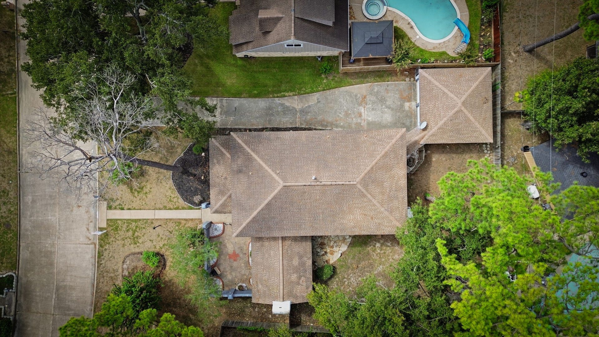 Large home with a spacious backyard featuring an outdoor patio area, ideal for relaxation and entertaining.