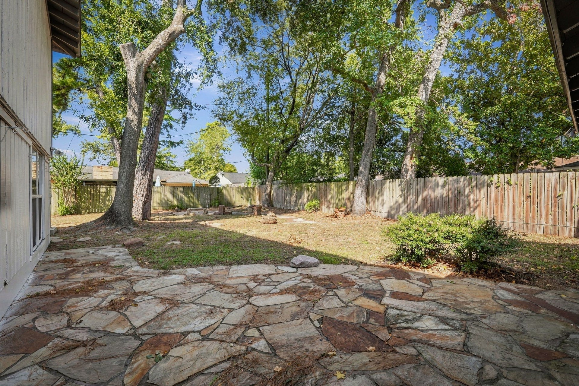 The patio and spacious backyard make a great space for relaxation.