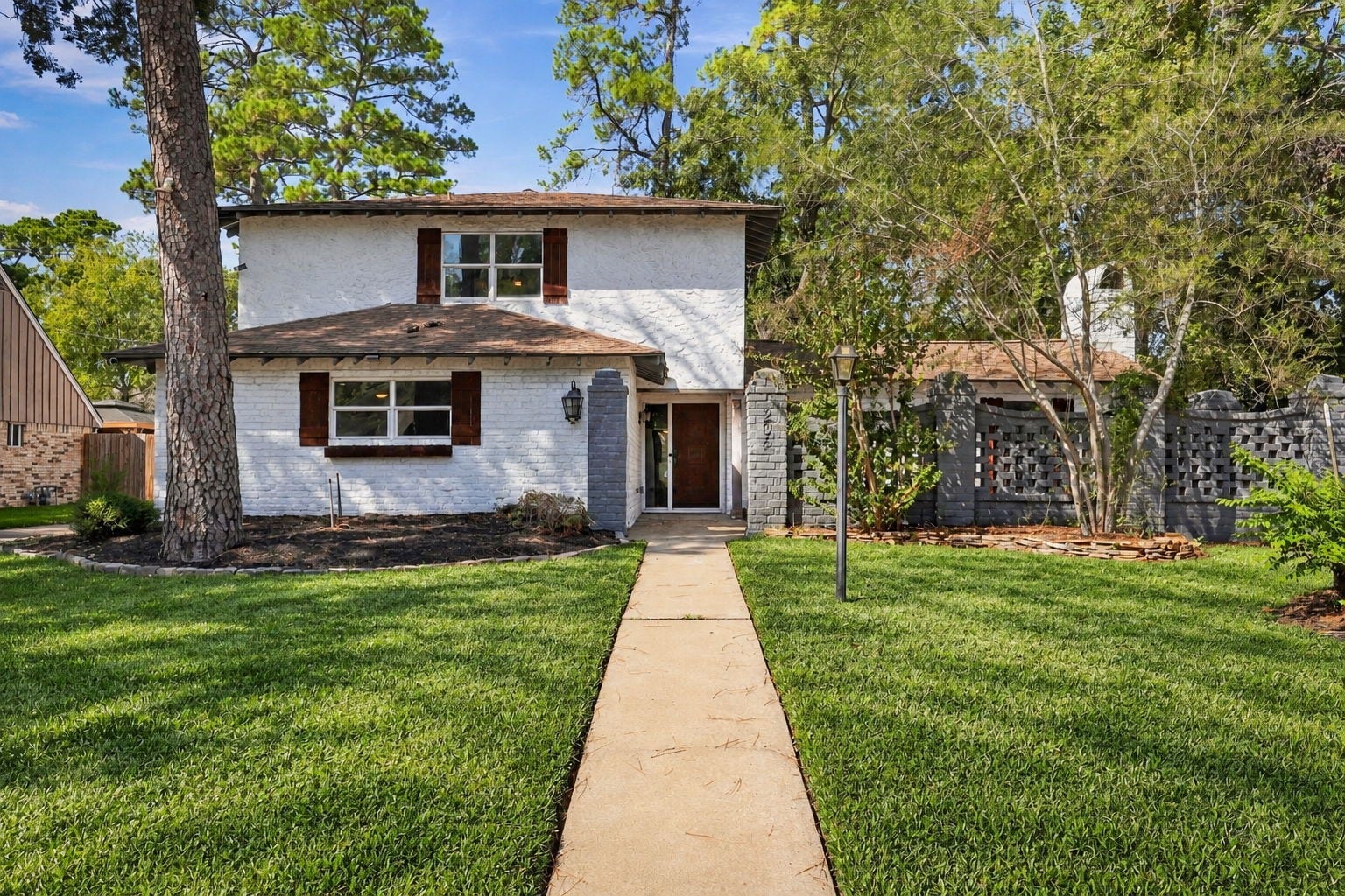 This home is beautifully set amidst gorgeous greenery and trees.