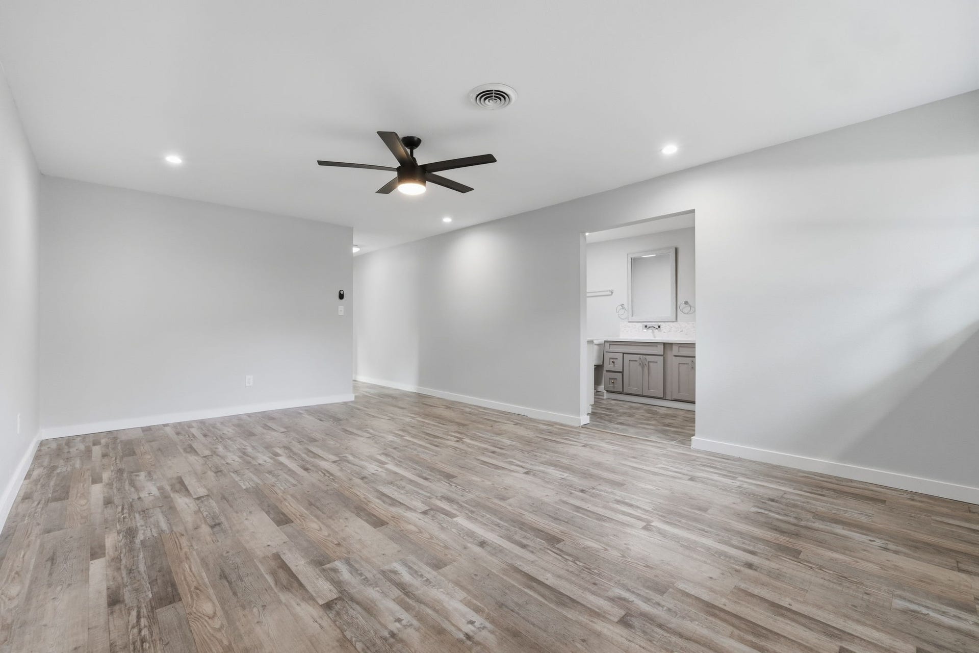 The primary bedroom has recessed lighting, open walkability, and seamlessly connects to the primary bathroom.