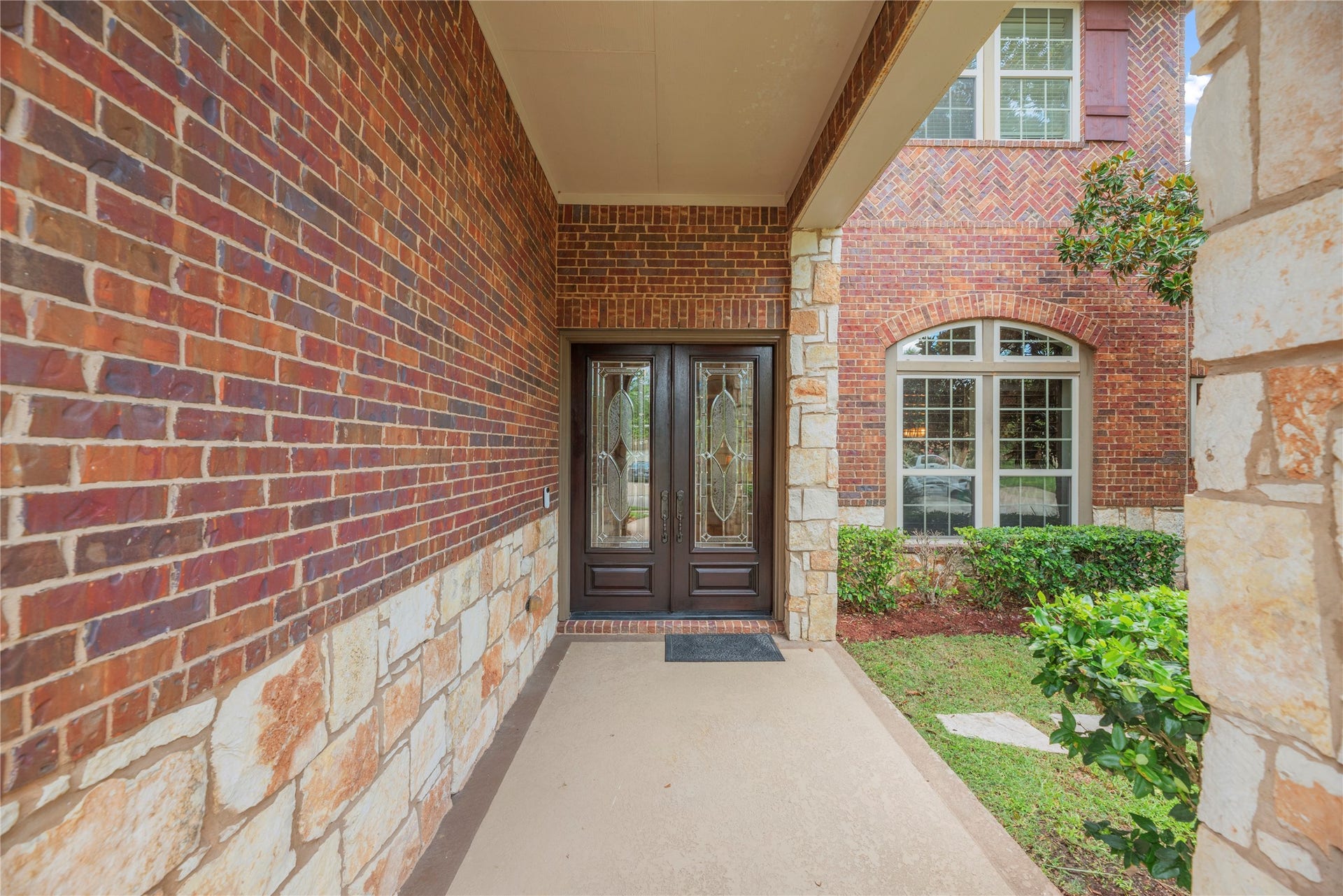 6115 Duke Trail Lane, Sugar Land, TX 77479 Front porch and entryway with lush landscaping.