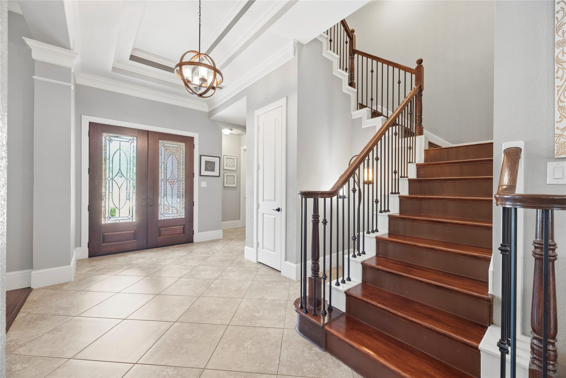 6115 Duke Trail Lane, Sugar Land, TX 77479 Wood double door entryway, coffered ceilings, and beautiful fixtures create a grand arrival experience.
