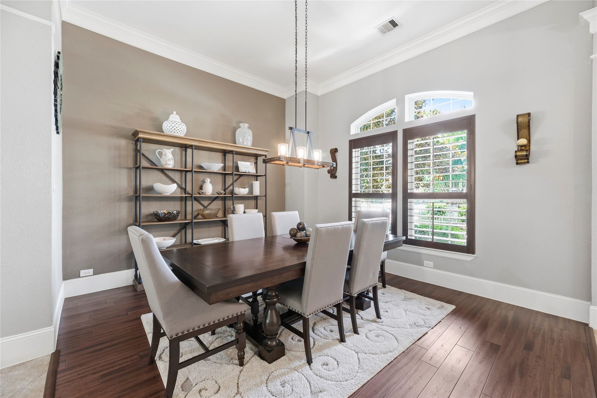 6115 Duke Trail Lane, Sugar Land, TX 77479 Host the next dinner party with confidence with this classy formal dining space. Featuring plantation shutters, crown molding, and an elegant light fixture.