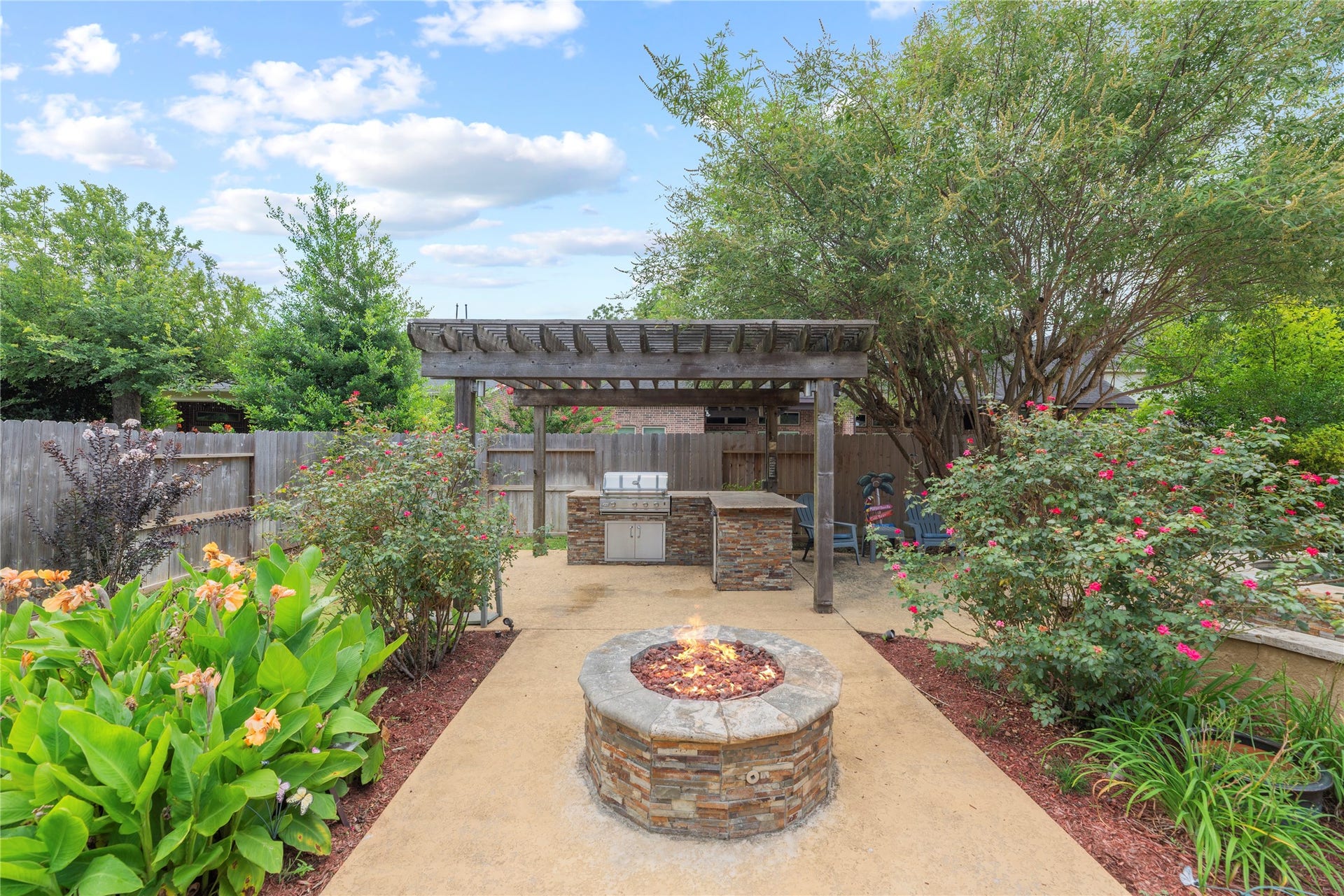 6115 Duke Trail Lane, Sugar Land, TX 77479 Outdoor kitchen and pergola + gas fire pit.