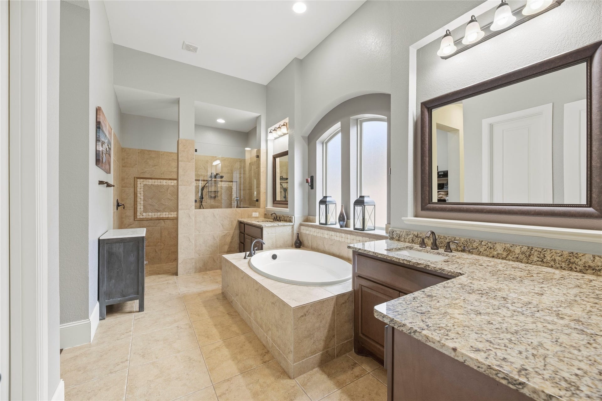 6115 Duke Trail Lane, Sugar Land, TX 77479 Beautiful primary bathroom featuring a large soaking tub, split vanities, granite countertops, and beautiful cabinetry.
