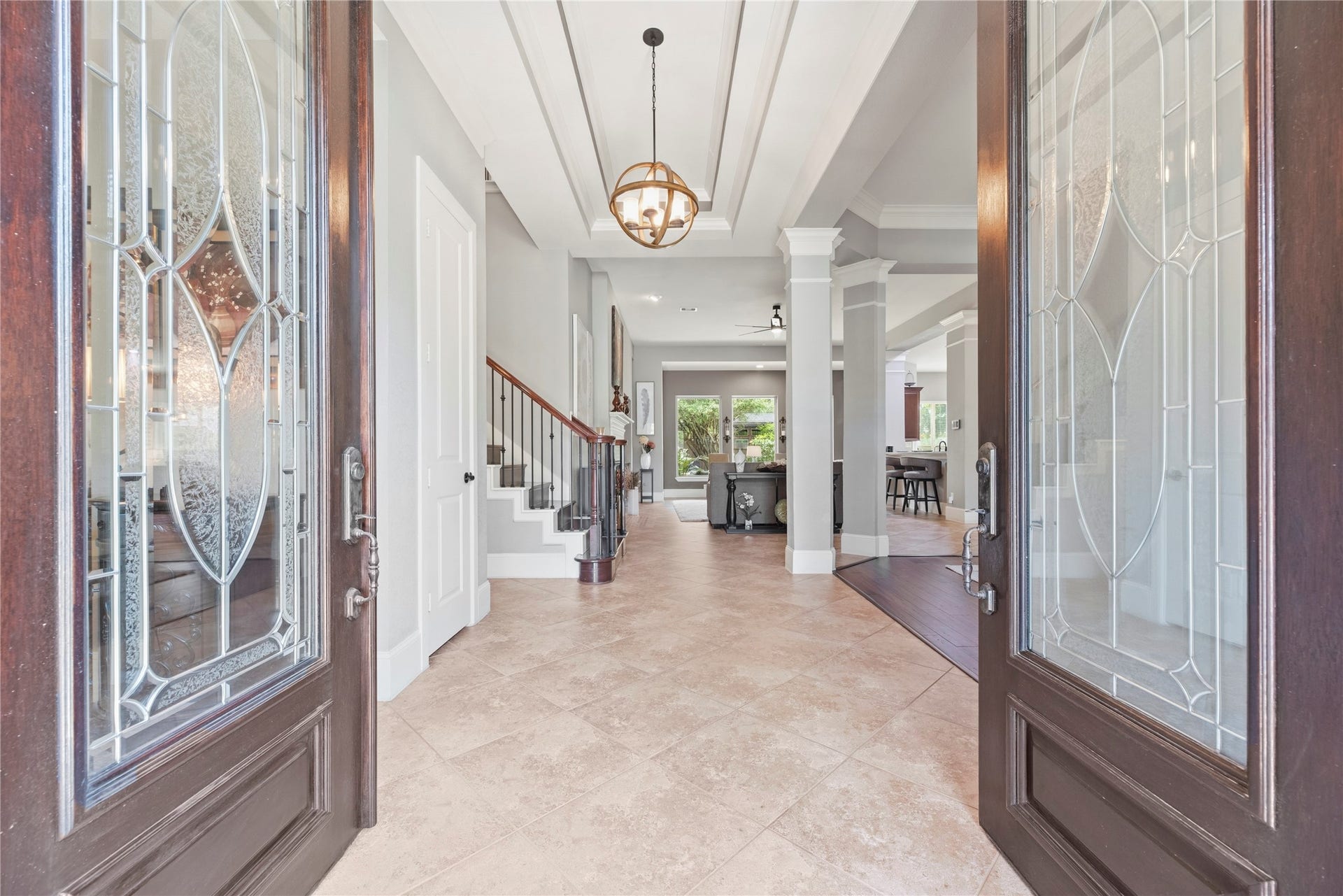 6115 Duke Trail Lane, Sugar Land, TX 77479 Wood double door entryway, coffered ceilings, and beautiful fixtures create a grand arrival experience.