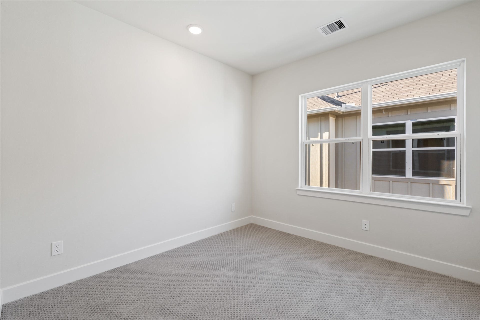 6441 Rena Street, Houston, TX 77092 Third bedroom with carpeted floors and a side-facing window that keeps the room feeling open without competing with any adjacent room.
