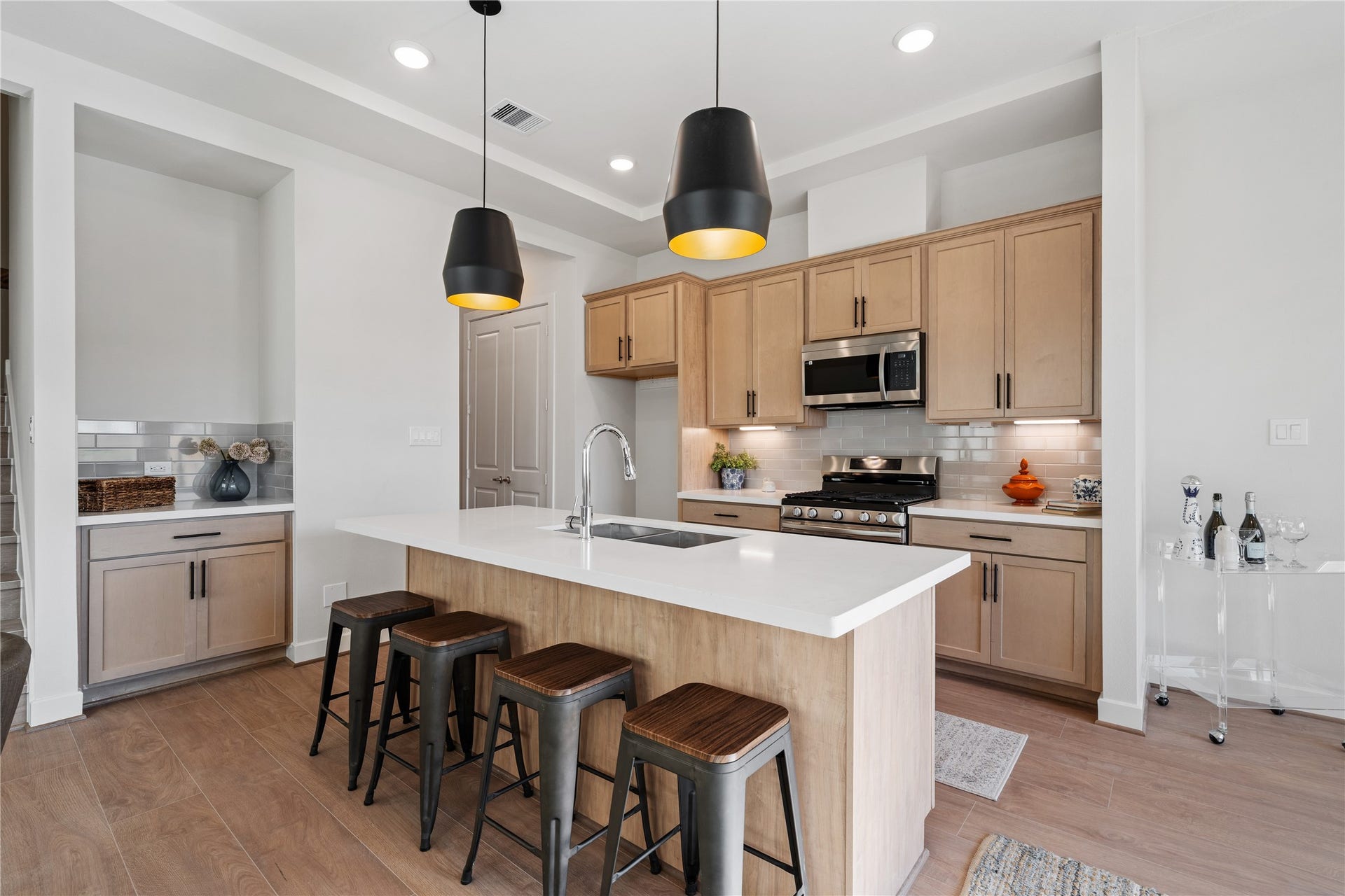 6441 Rena Street, Houston, TX 77092 A quartz island with built-in bar seating anchors the kitchen and gives the space a natural gathering point beyond just cooking.