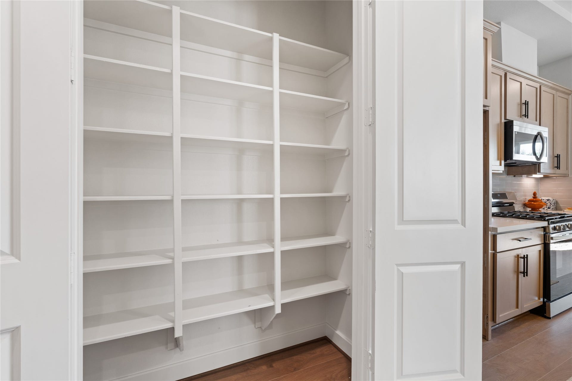 6441 Rena Street, Houston, TX 77092 Reach-in pantry with full height shelving keeps dry goods and kitchen overflow organized and completely out of sight.
