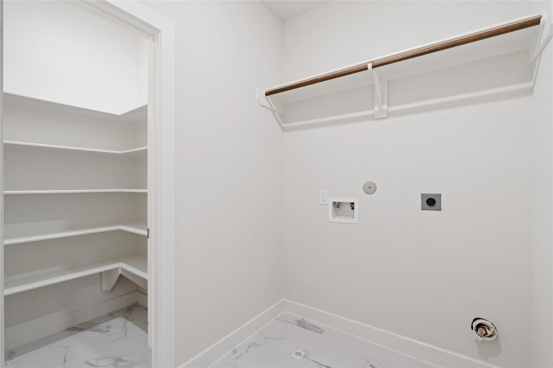 6441 Rena Street, Houston, TX 77092 Dedicated upstairs laundry room with built-in shelving and full-size washer/dryer hookups, keeping laundry off the main floor entirely.