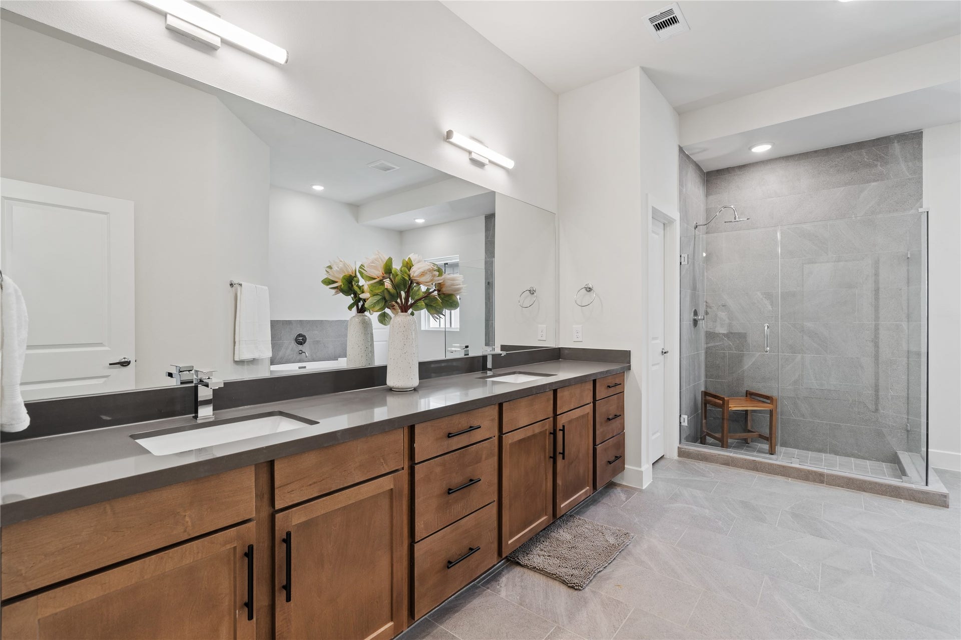 6441 Rena Street, Houston, TX 77092 A primary bath of this size is uncommon at this price point, with a wide double-sink vanity and glass-enclosed shower wrapped in large format tile.