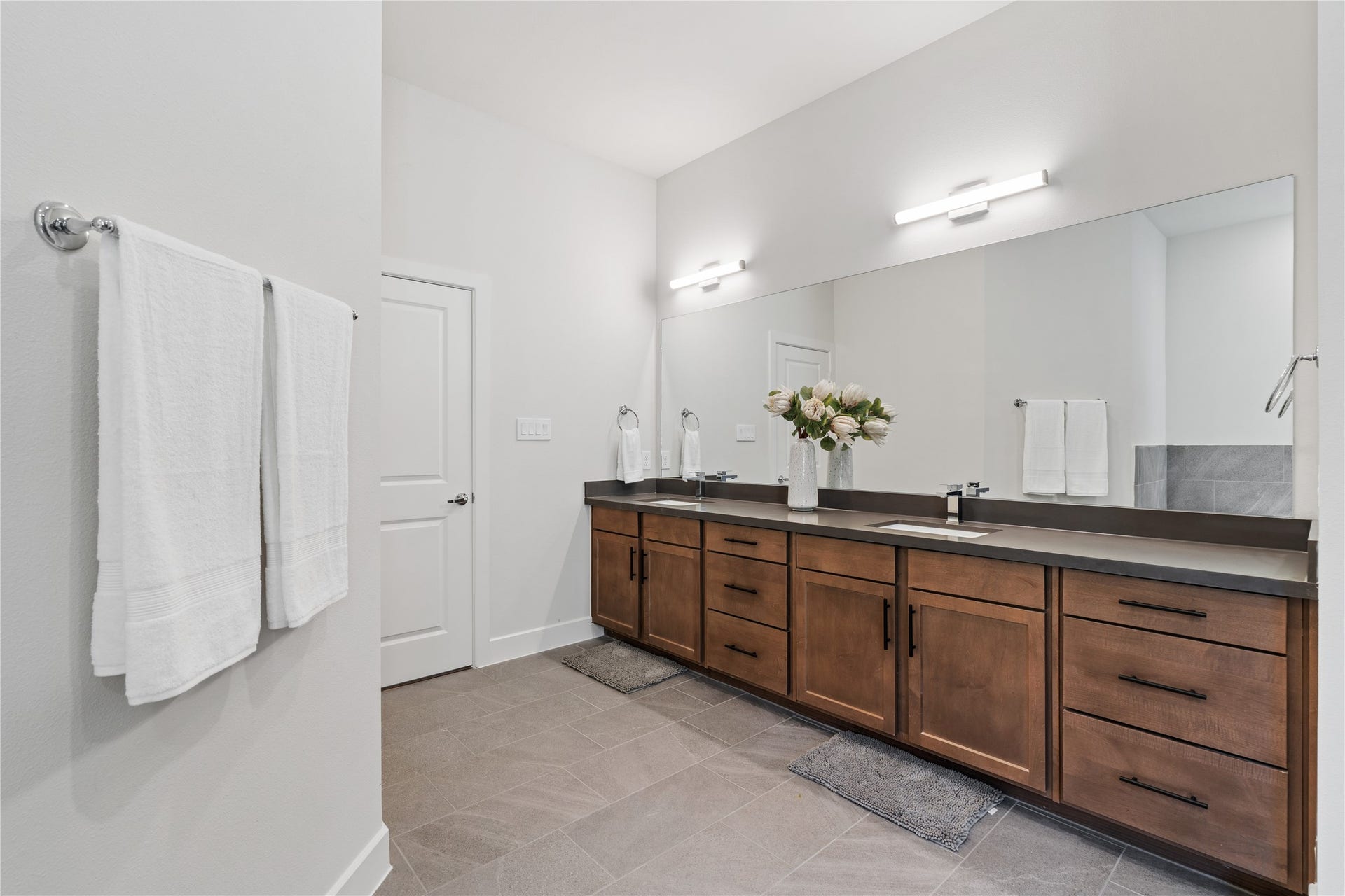 6441 Rena Street, Houston, TX 77092 Natural wood cabinetry and dark quartz surfaces in the primary bath create a warm, moody finish that still feels clean and current.