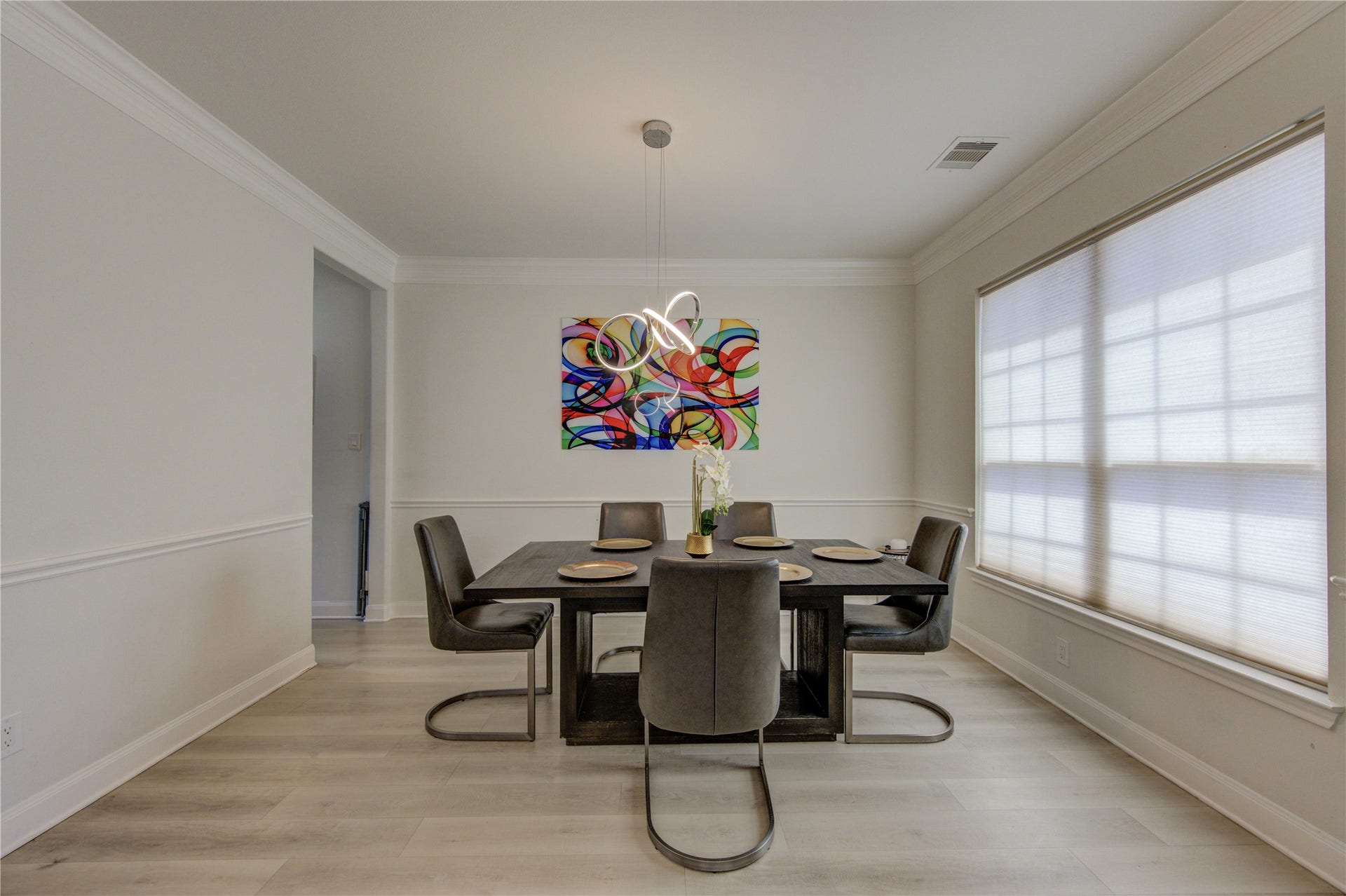 Beautifully designed dining area filled with natural light, featuring elegant finishes and a modern aesthetic. The space showcases stylish flooring, contemporary lighting, and ample room for entertaining. Large windows create a bright and inviting atmosphere, making it perfect for both everyday dining and special gatherings. Seamlessly connected to the living areas, this space offers both comfort and sophistication