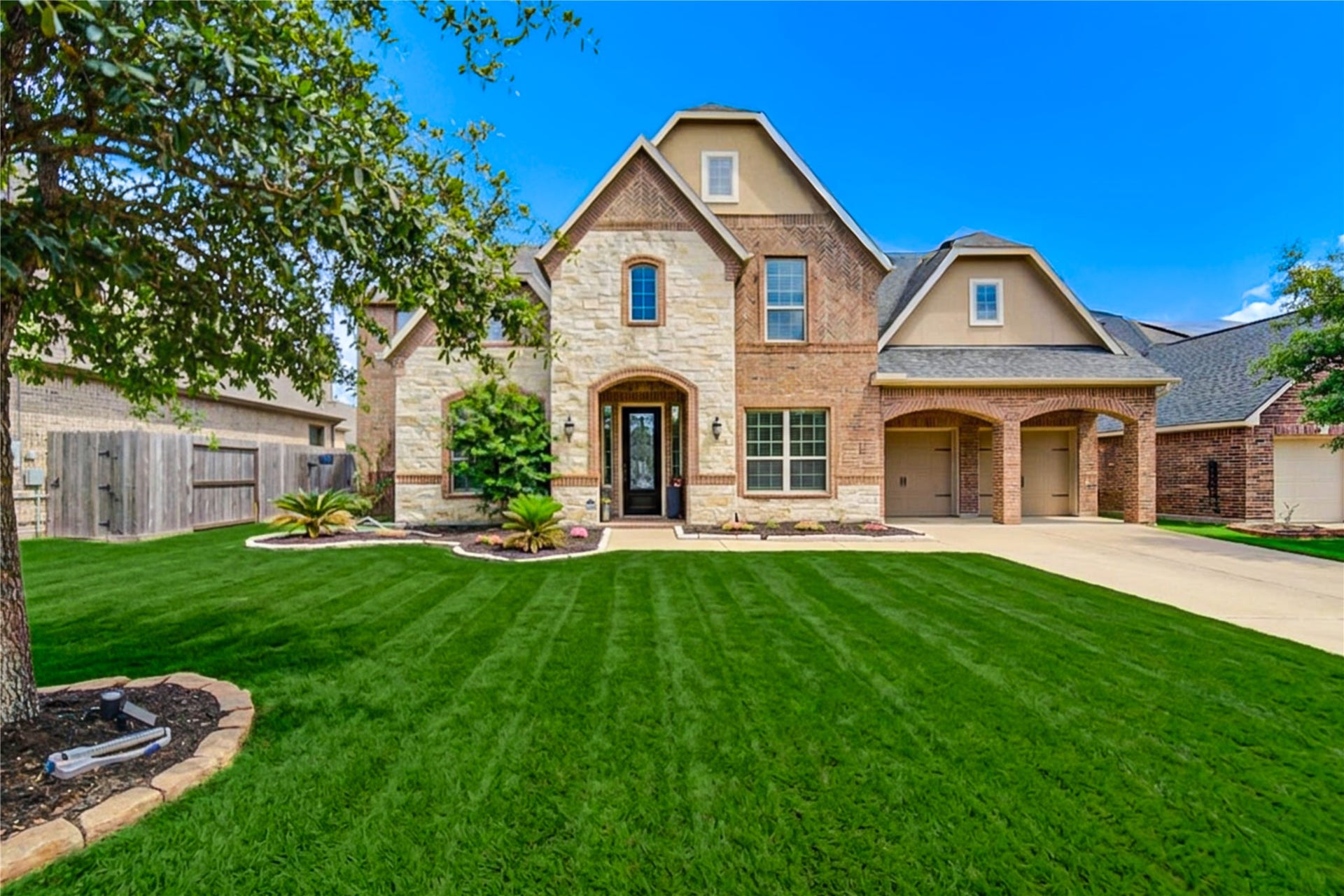 Beautiful front elevation with manicured lawn and mature landscaping, located on a quiet cul-de-sac. This elegant home features a charming faade, arched entry, and exceptional curb appeal in the highly desirable Firethorne community.