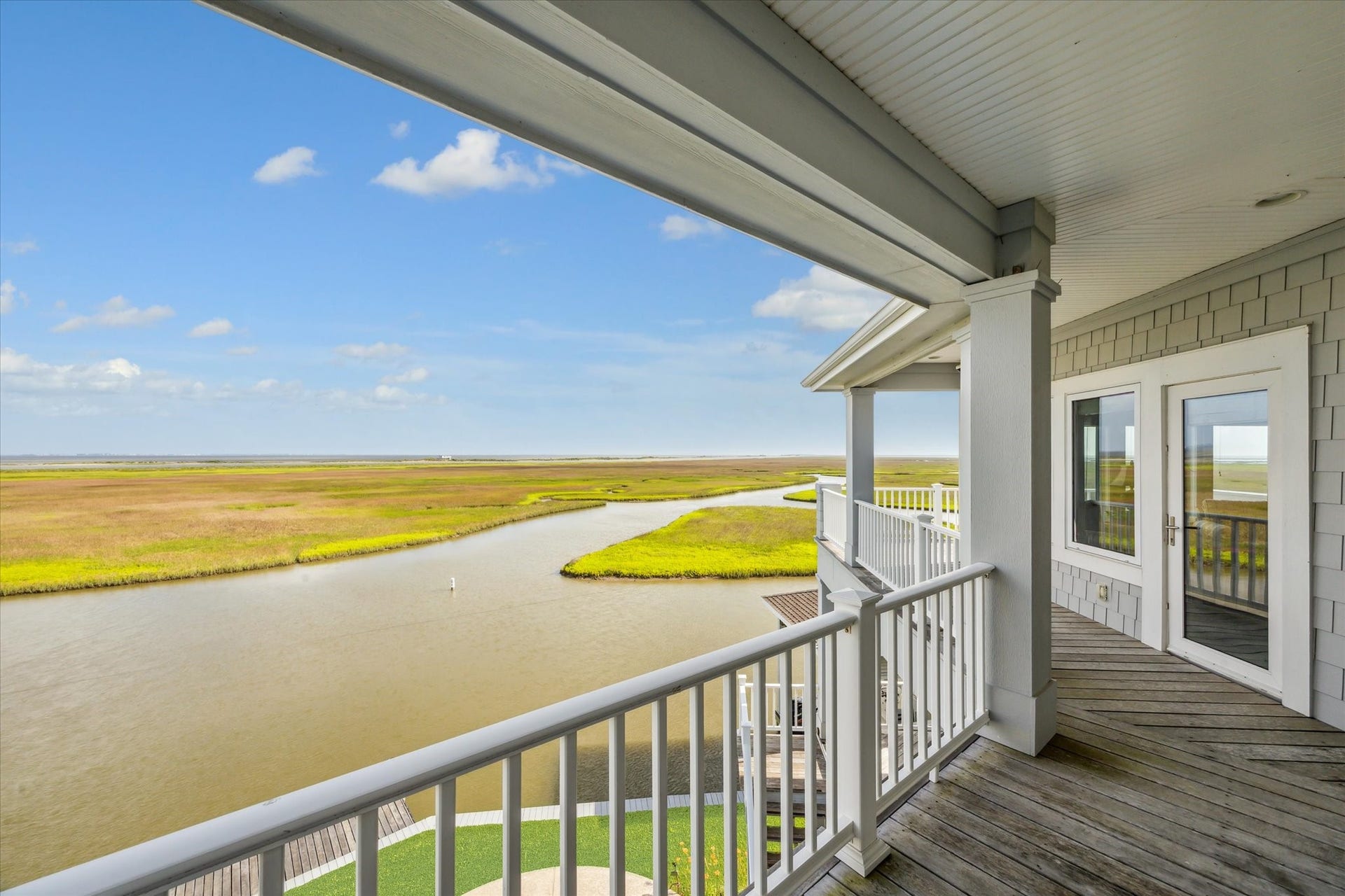 1 Shell Key, Hitchcock, TX 77563 The top-level covered balcony offers panoramic, elevated views of the surrounding wetlands and West Galveston Bay
