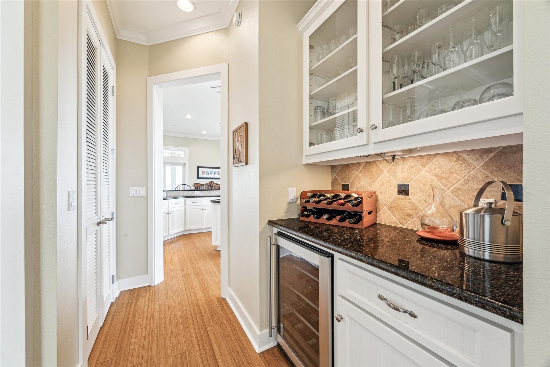 1 Shell Key, Hitchcock, TX 77563 Large butlers pantry enhances the kitchens functionality, featuring a wine cooler for effortless entertaining, elegant glass-front cabinetry for display, and under-cabinet lighting that adds both ambiance and practicality